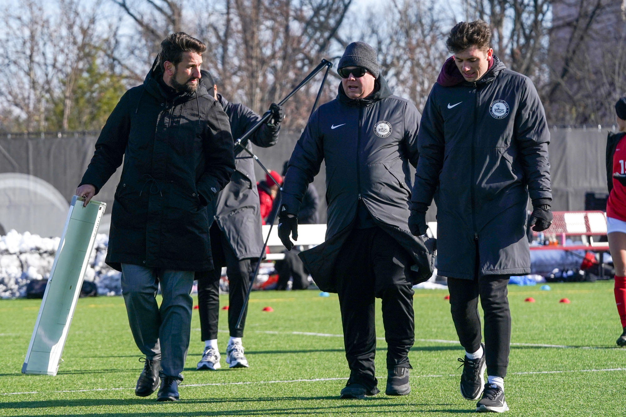 UMSL women's soccer coaching staff talk over halftime adjustments in the Midwest Region championship game at Maryville