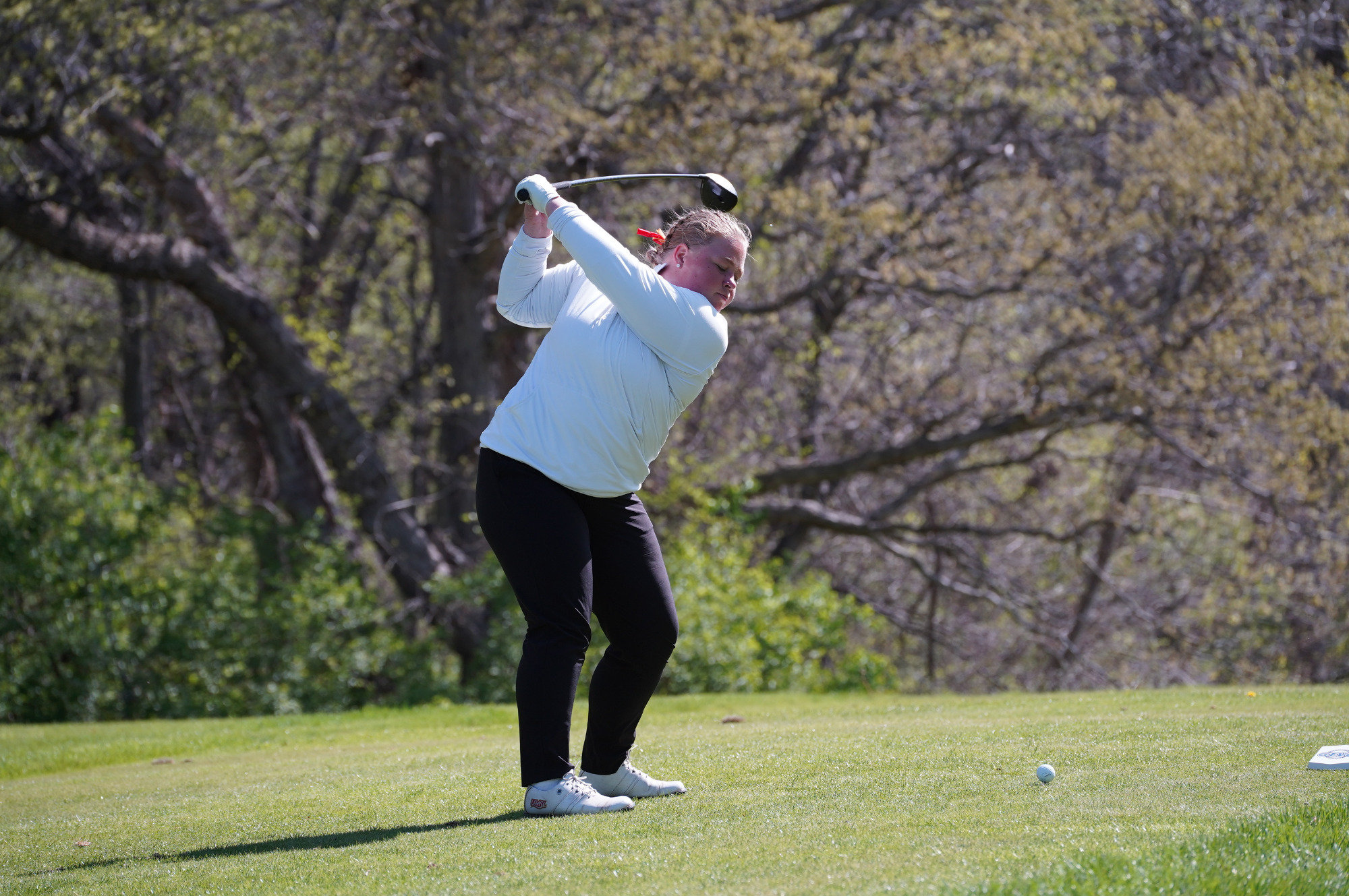 Wilma Zanderau tees off in a GLVC semifinal match