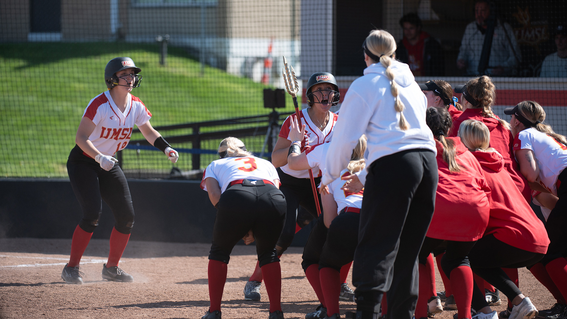 The Triton softball team celebrates hitting a home run