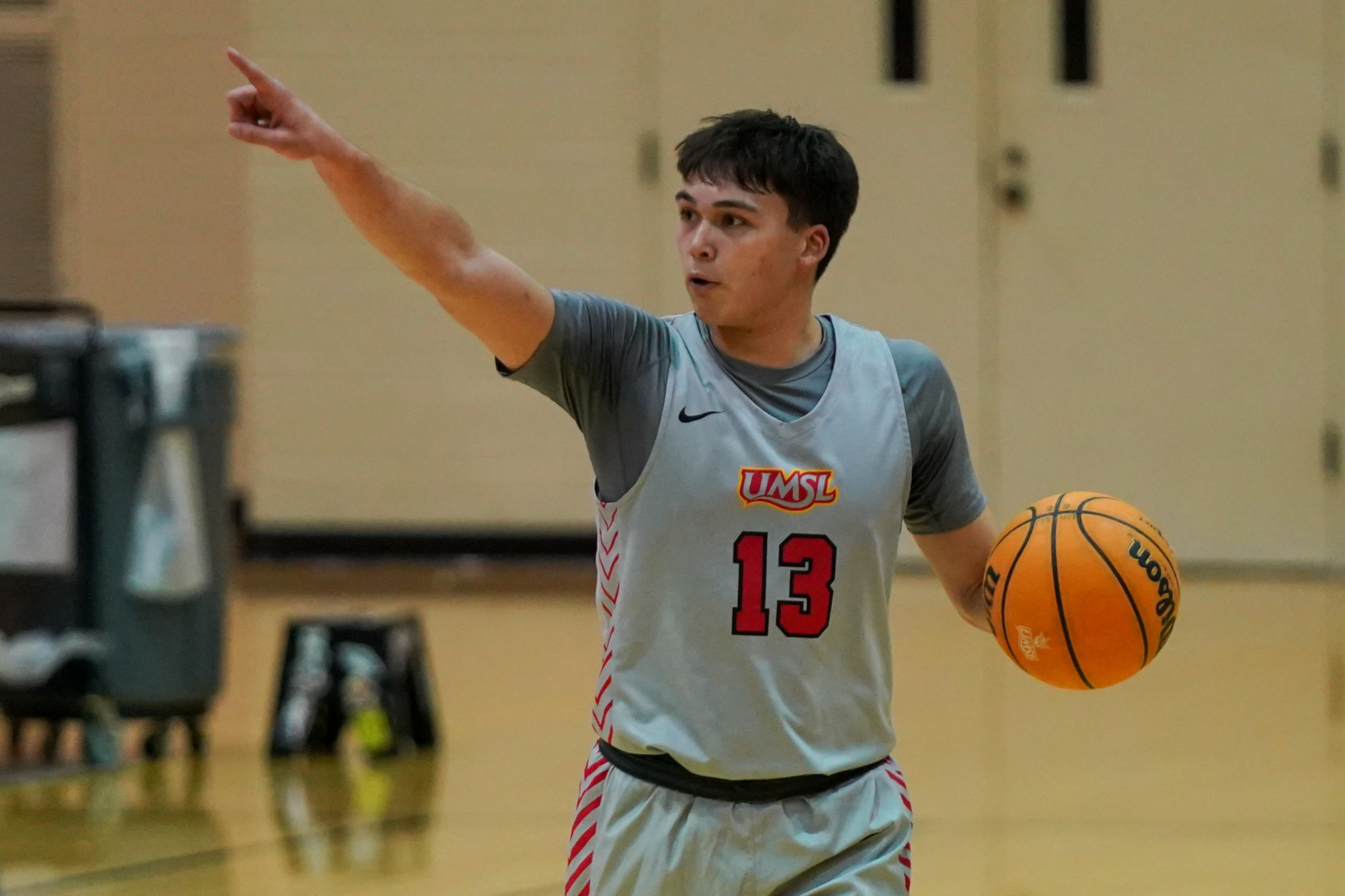 Miles Boland directs traffic in a men's basketball game against Quincy