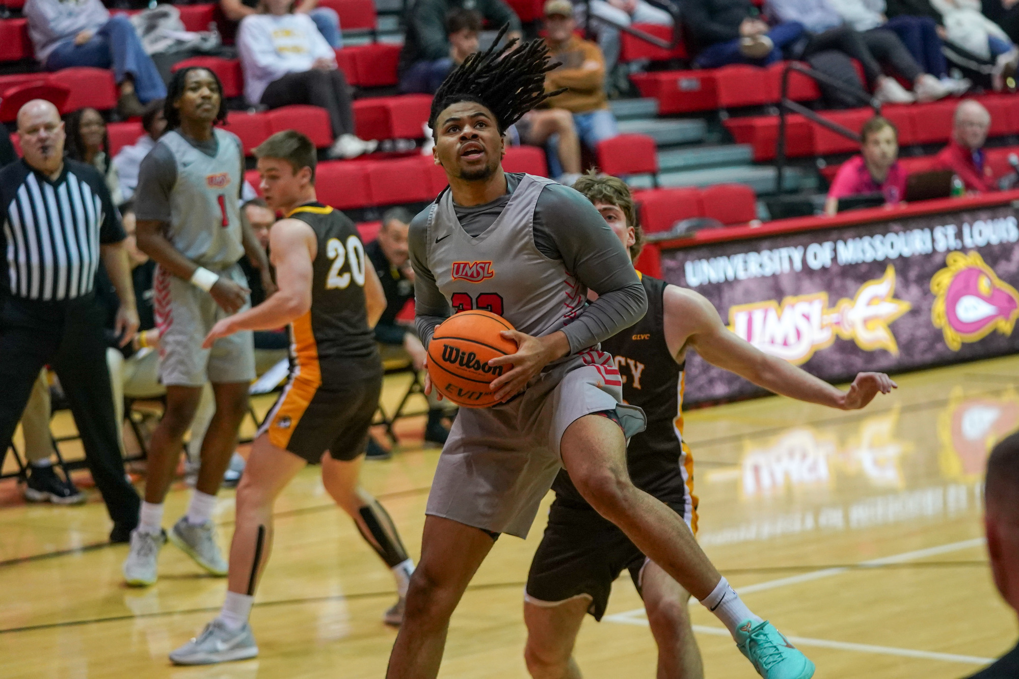 Demetris Phillips looks to score after pulling down a rebound against Quincy