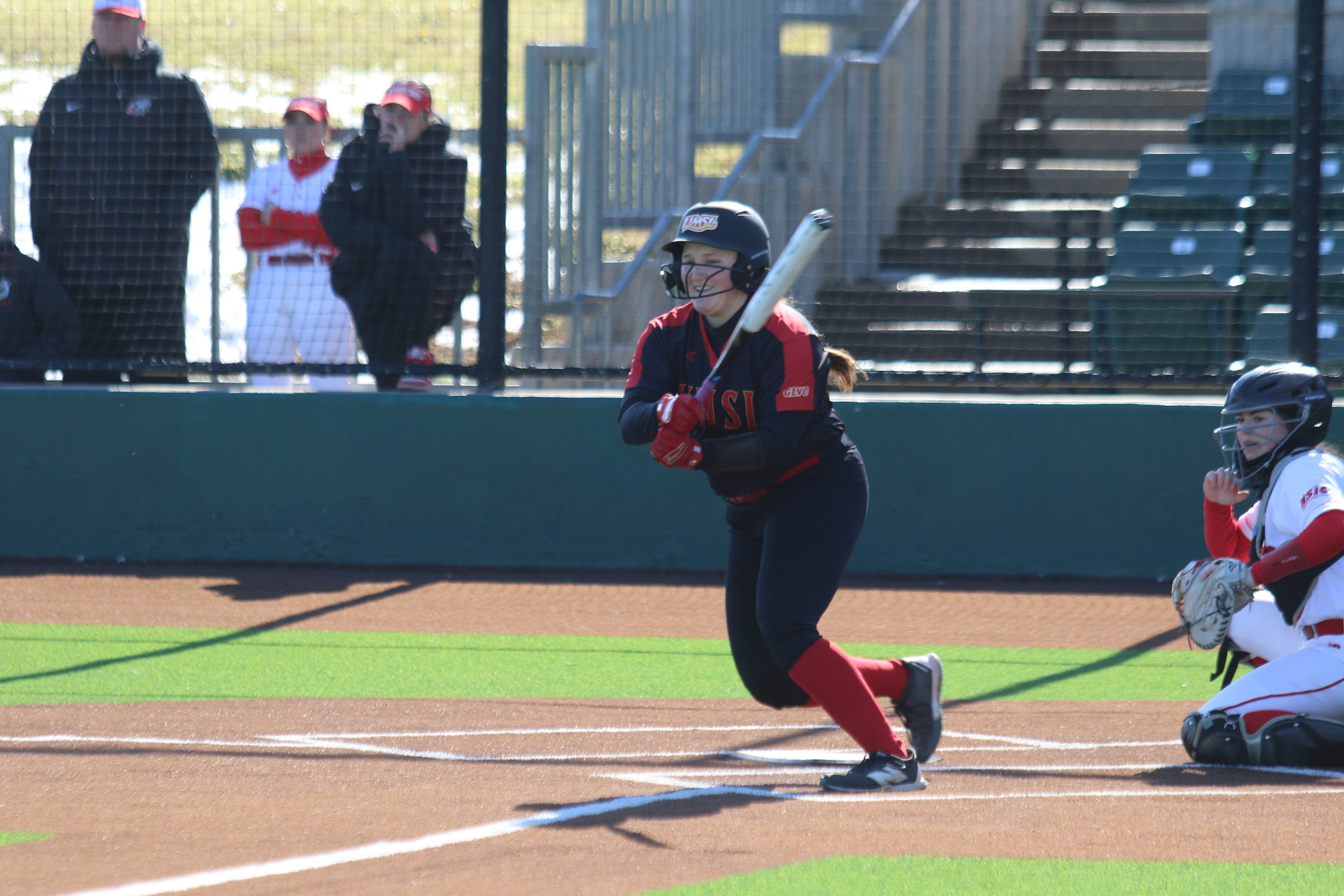 Phoebe Miller follows through her swing after putting a ball in play.