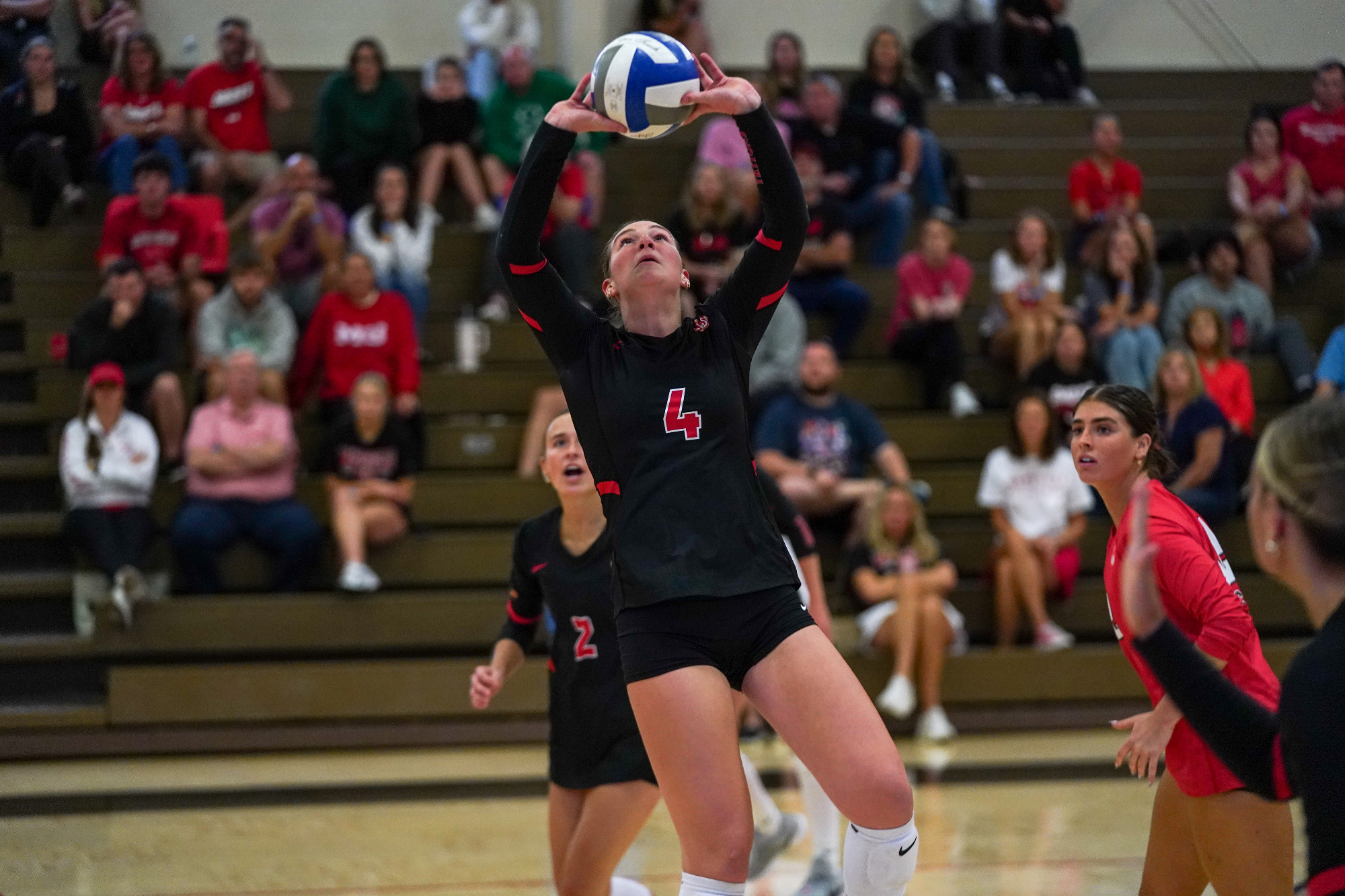 Marly Burbach sets the ball for one of her attackers in a volleyball match at Maryville University