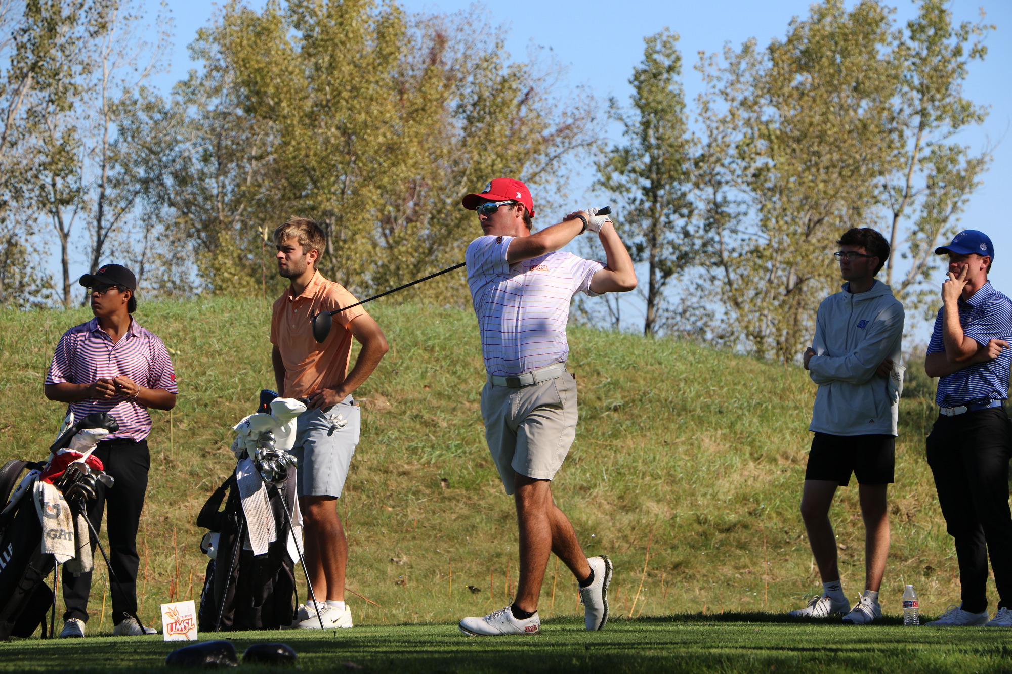 Logan Mayo follows the golf ball after teeing off on the ninth hole at Rock Hollow Golf Club