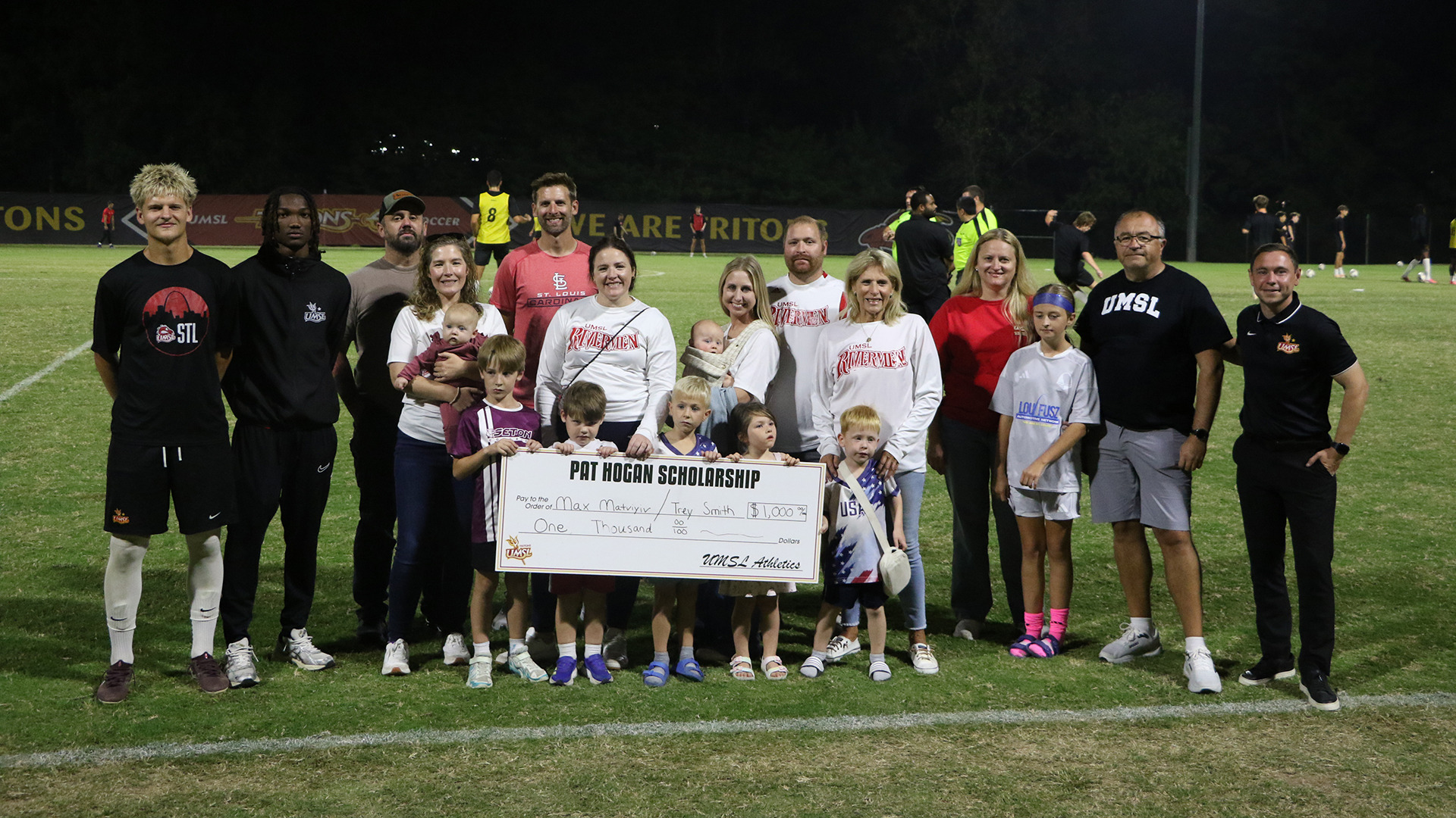 Members of the Pat Hogan family present UMSL men's soccer players Max Matviyiv and Trey Smith with scholarships