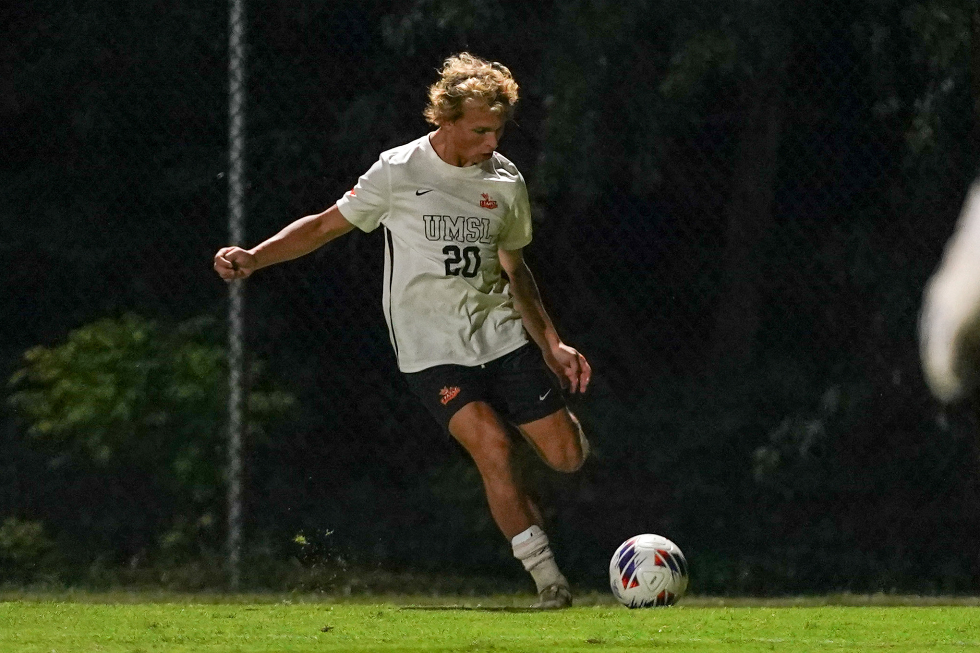 Gibson Hunt prepares to cross the soccer ball in an NCAA soccer match against Quincy