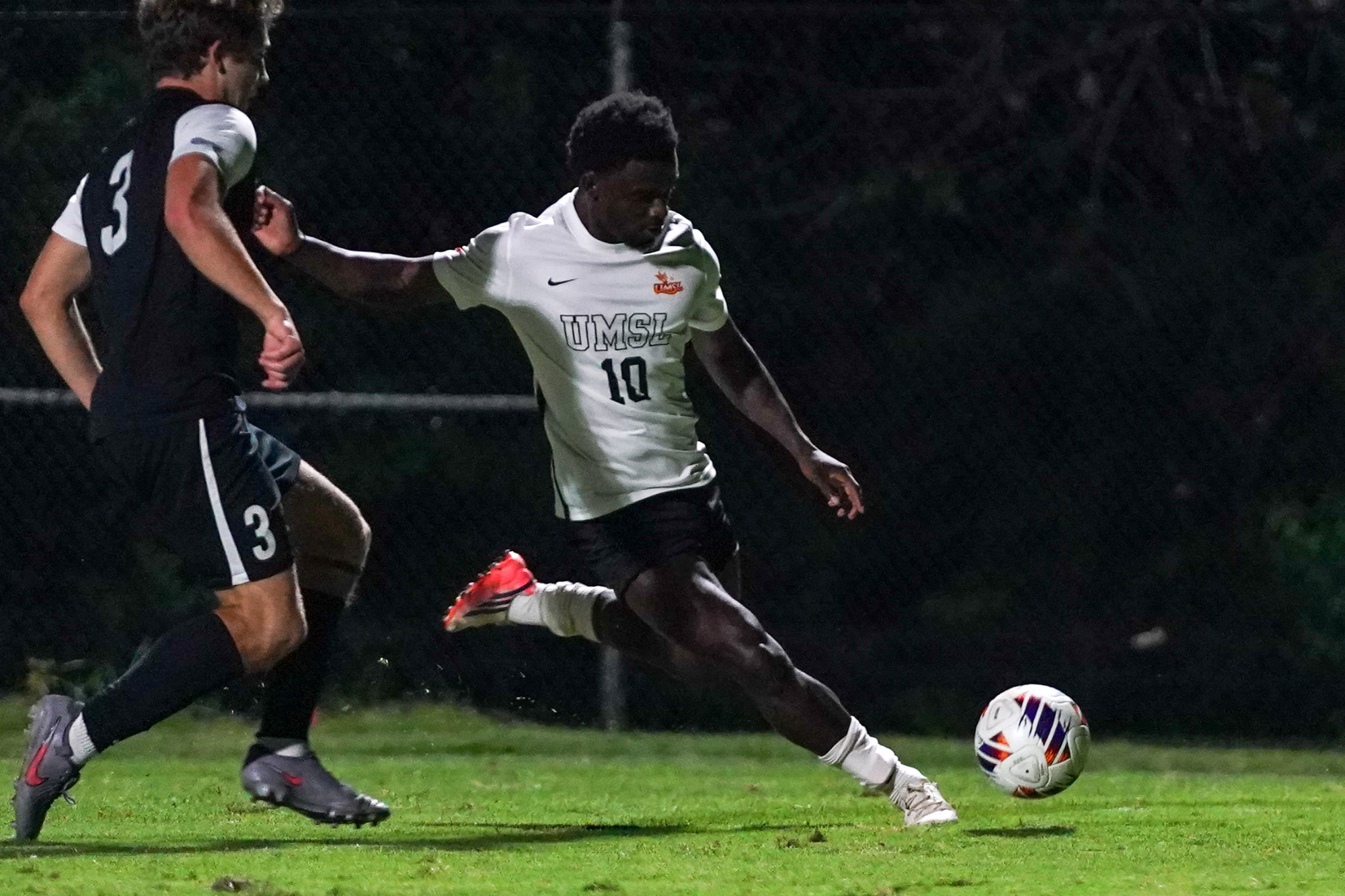 Melo Mensah looks to fire a cross in a men's soccer match against Quincy