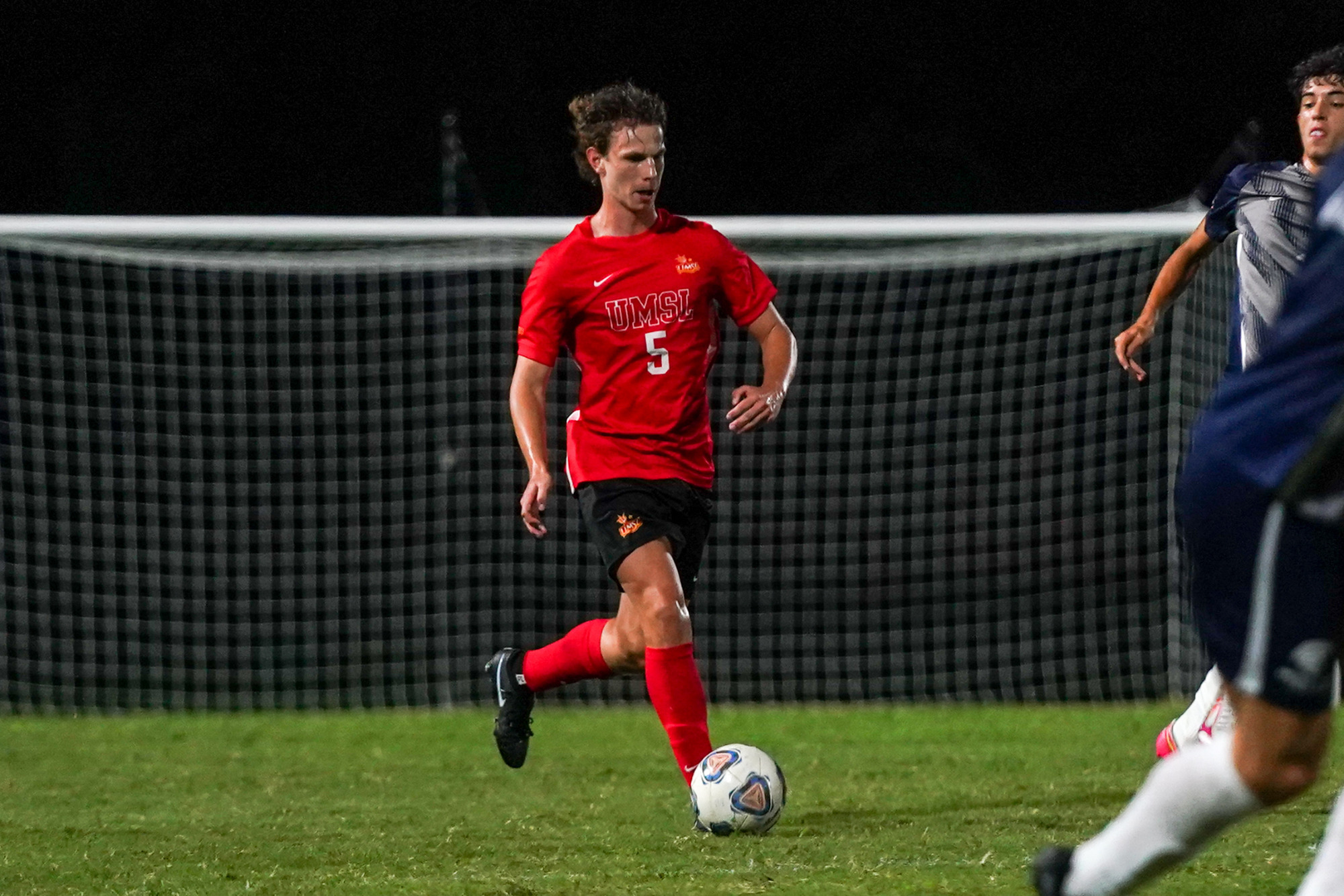 Nico Wingren dribbles the soccer ball in an exhibition match against Missouri Baptist