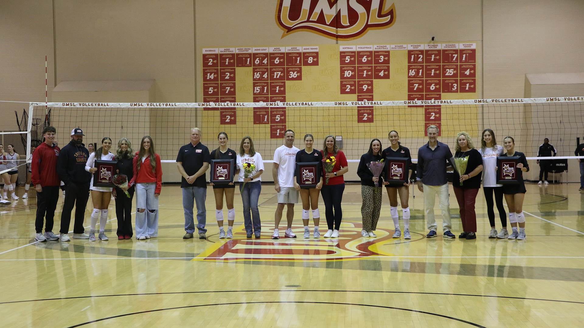 The University of Missouri-St. Louis volleyball team honored its five seniors prior to the start of Saturday's match against the University of Indianapolis. The seniors pose for a group photo with their families.