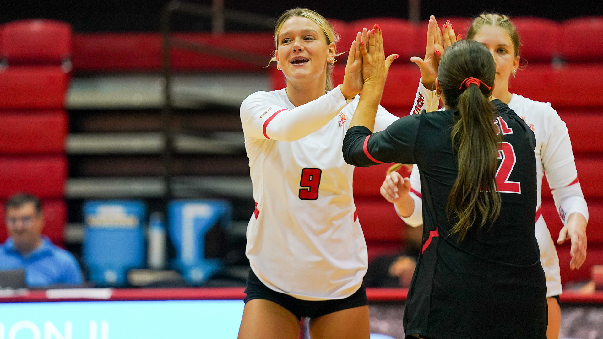 Maggie Johnson (#9) high fives Skylar Weaver (#12) in a match against Southwest Baptist