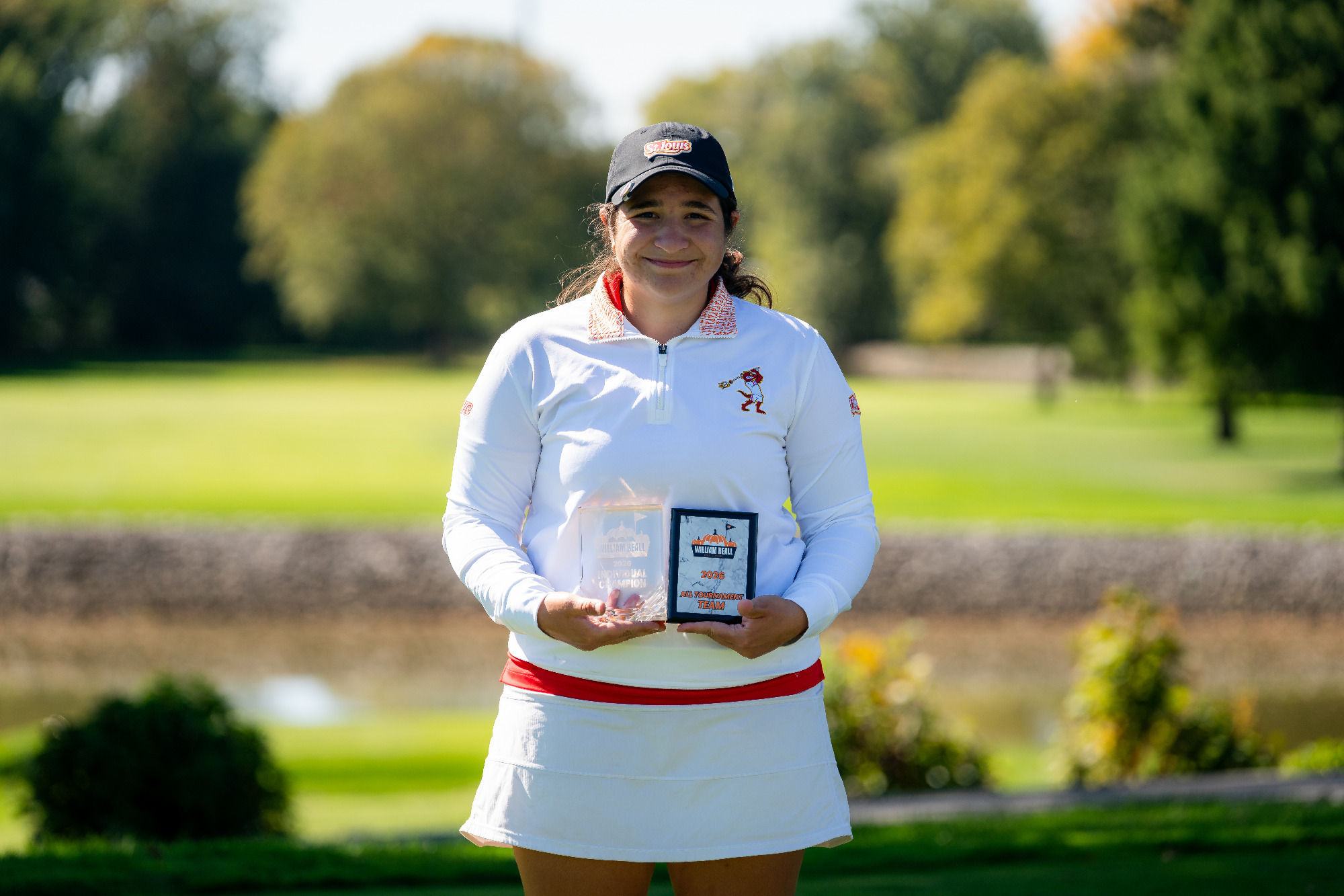 Mayan Covarrubias holds her all=tournament plaque and championship trophy at the Beall Fall Classic