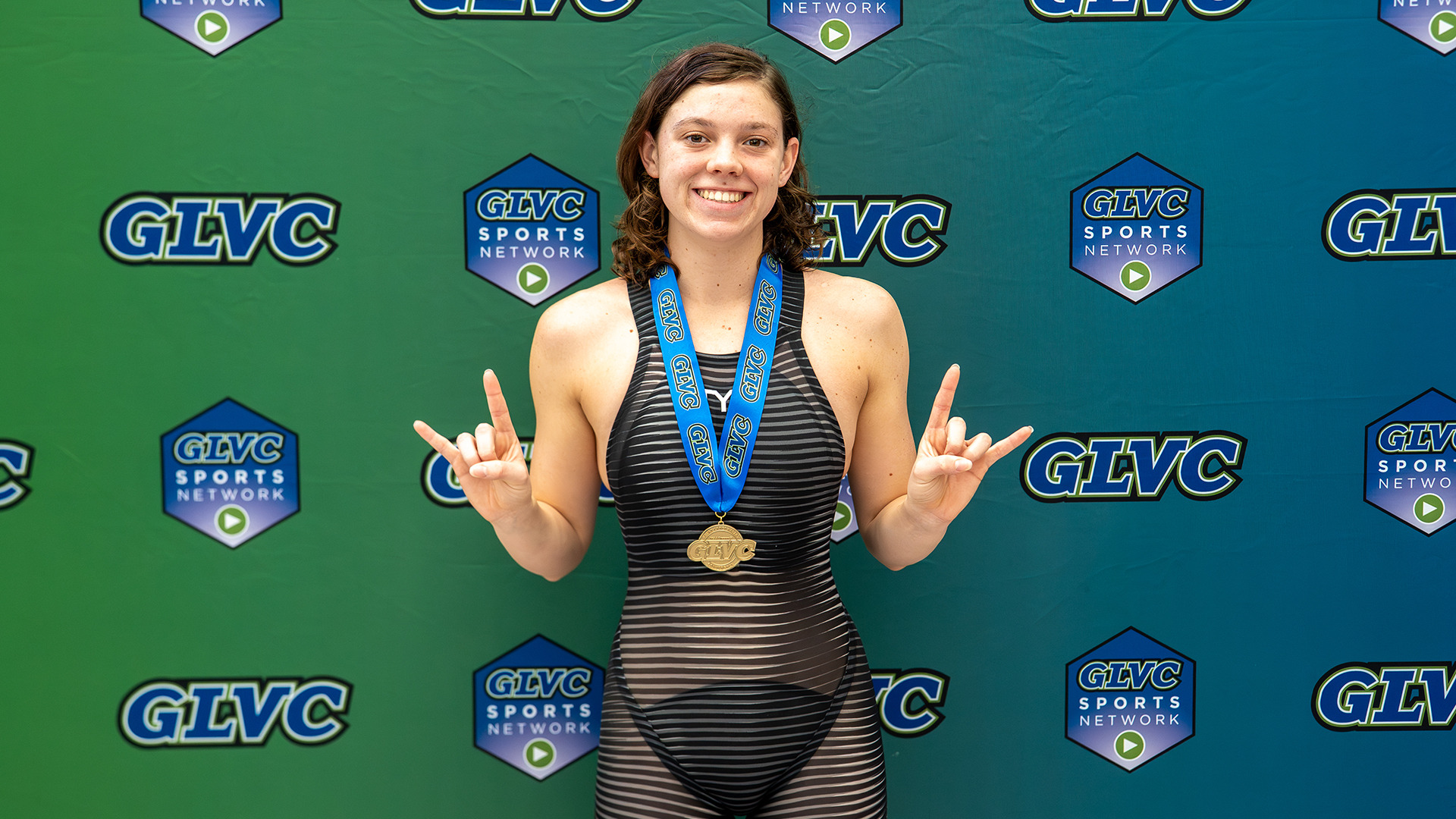 Justice Beard poses for a picture wearing her gold medal after winning the women's 1,000-yard freestyle race at the 2026 Great Lakes Valley Conference Championship meet.