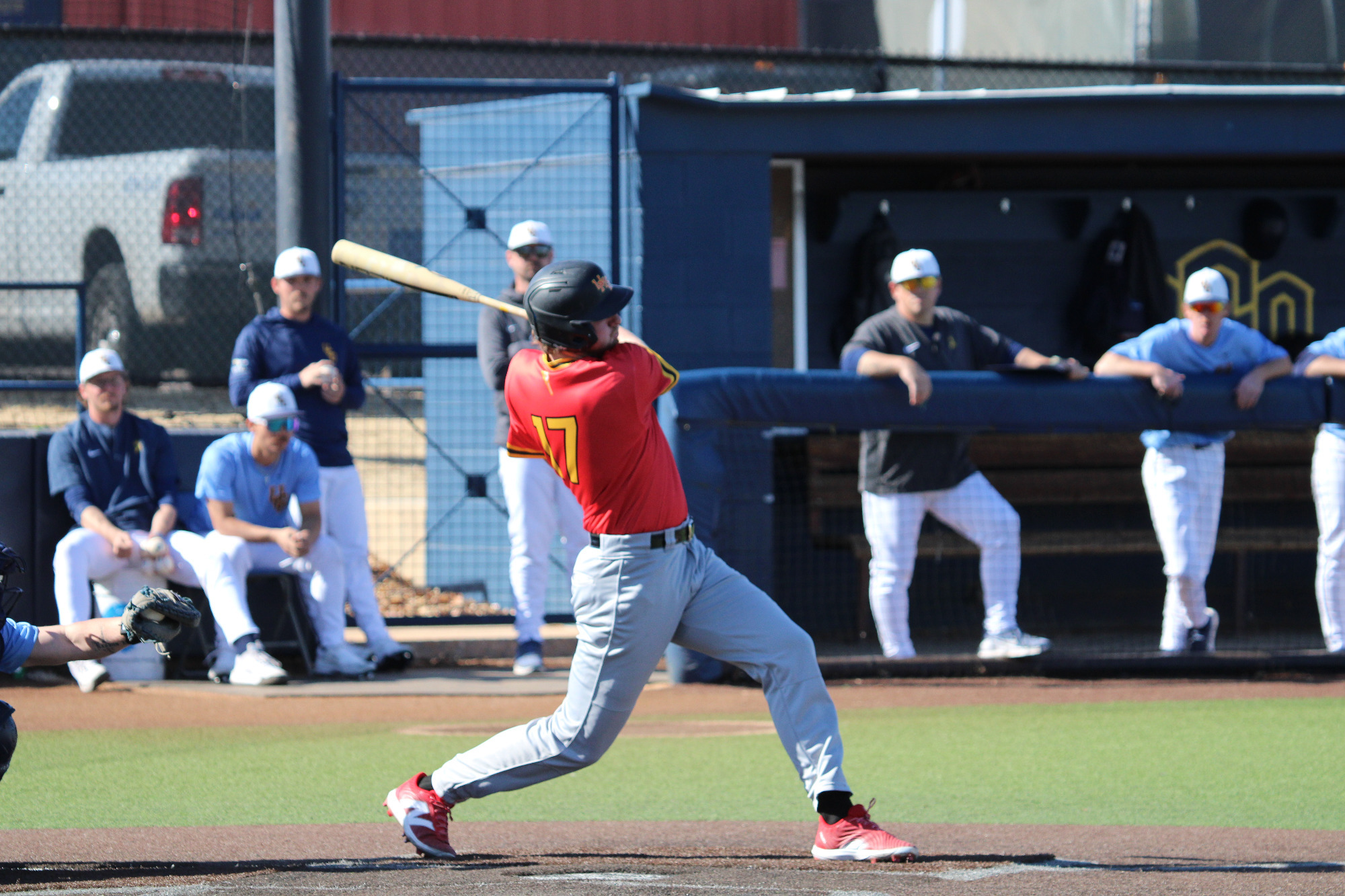 Justin Terhaar follows through on his swing after hitting a baseball against Central Oklahoma on Februrary 7