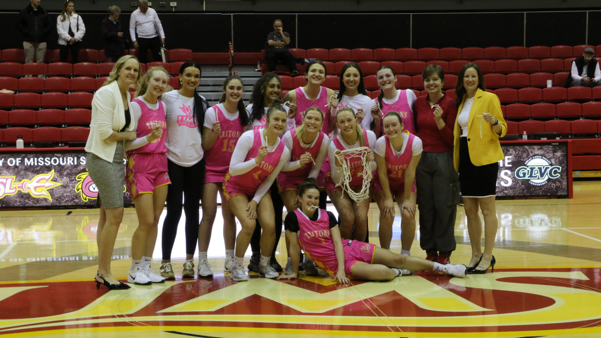 UMSL Women's Basketball Team Celebration Pic after cutting down the net after clinching its first conference title in program history.
