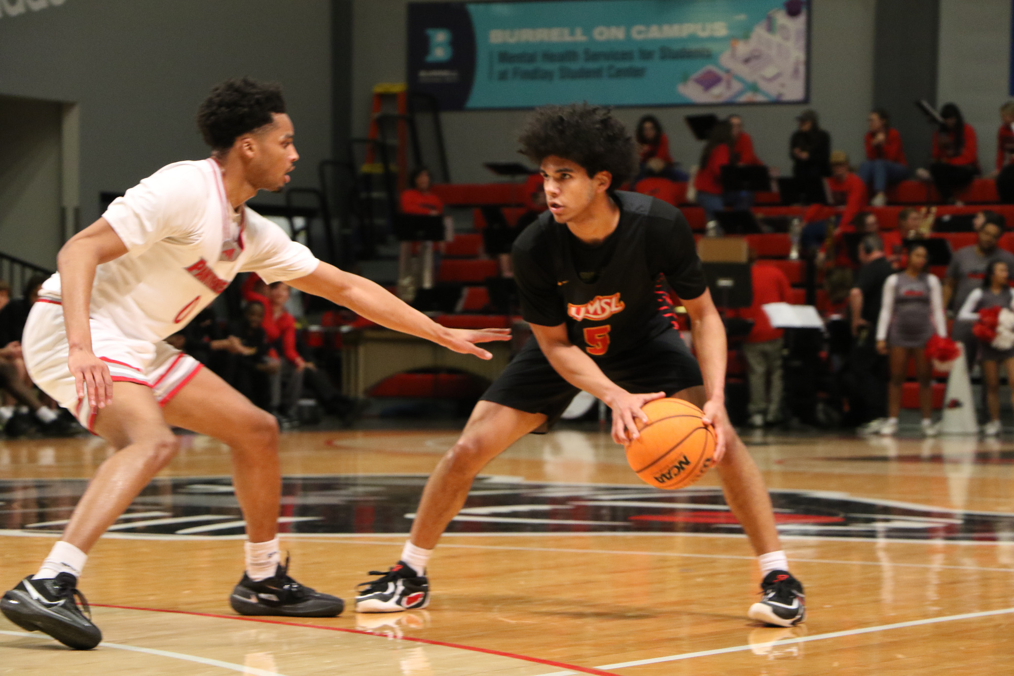 Taye Moore looks to make a pass as he's guarded tightly by a Drury defender