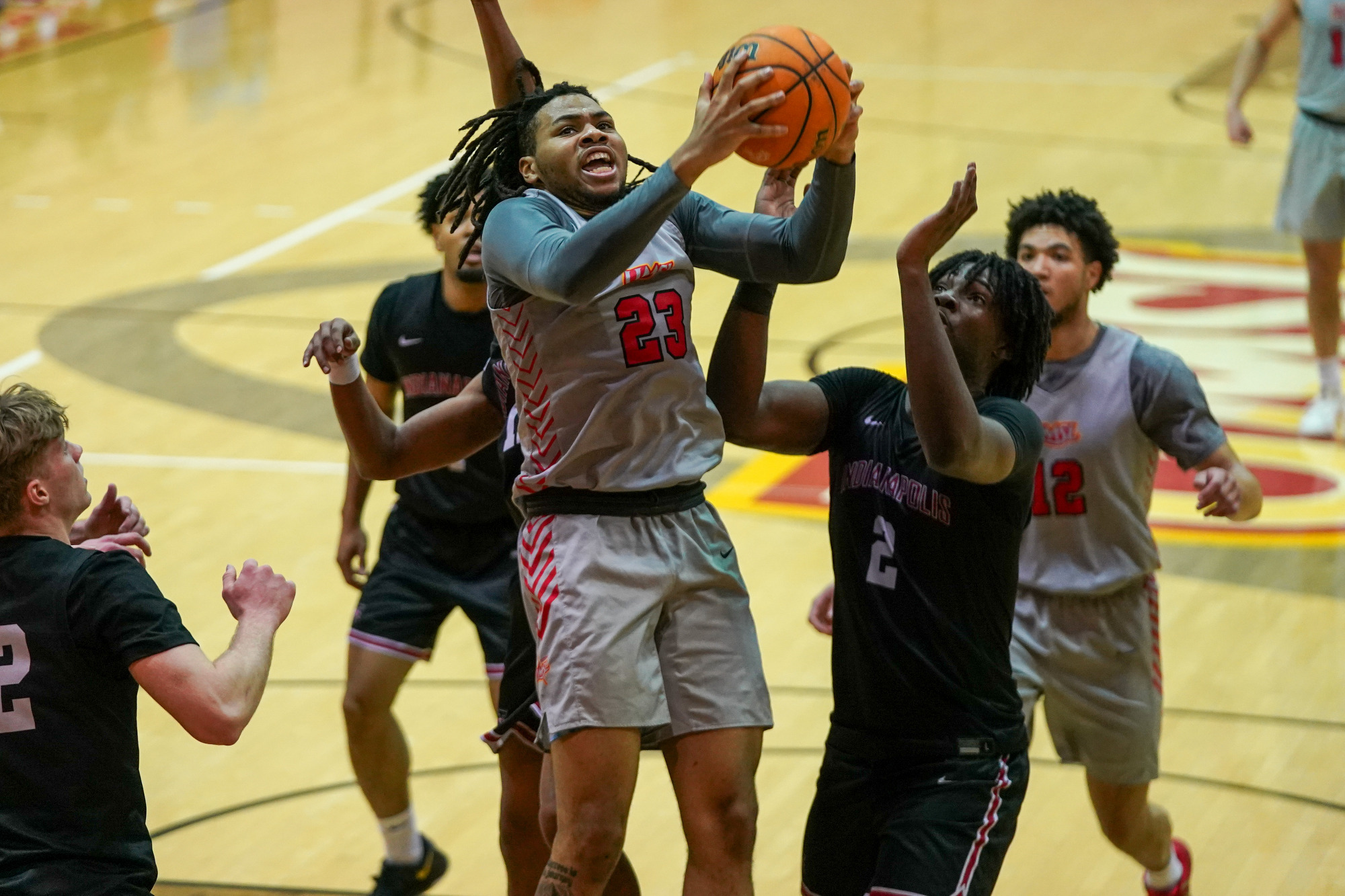 Demeteris Phillips goes up for a shot attempt between three University of Indianapolis defenders in a game on Thursday (February 5, 2026).
