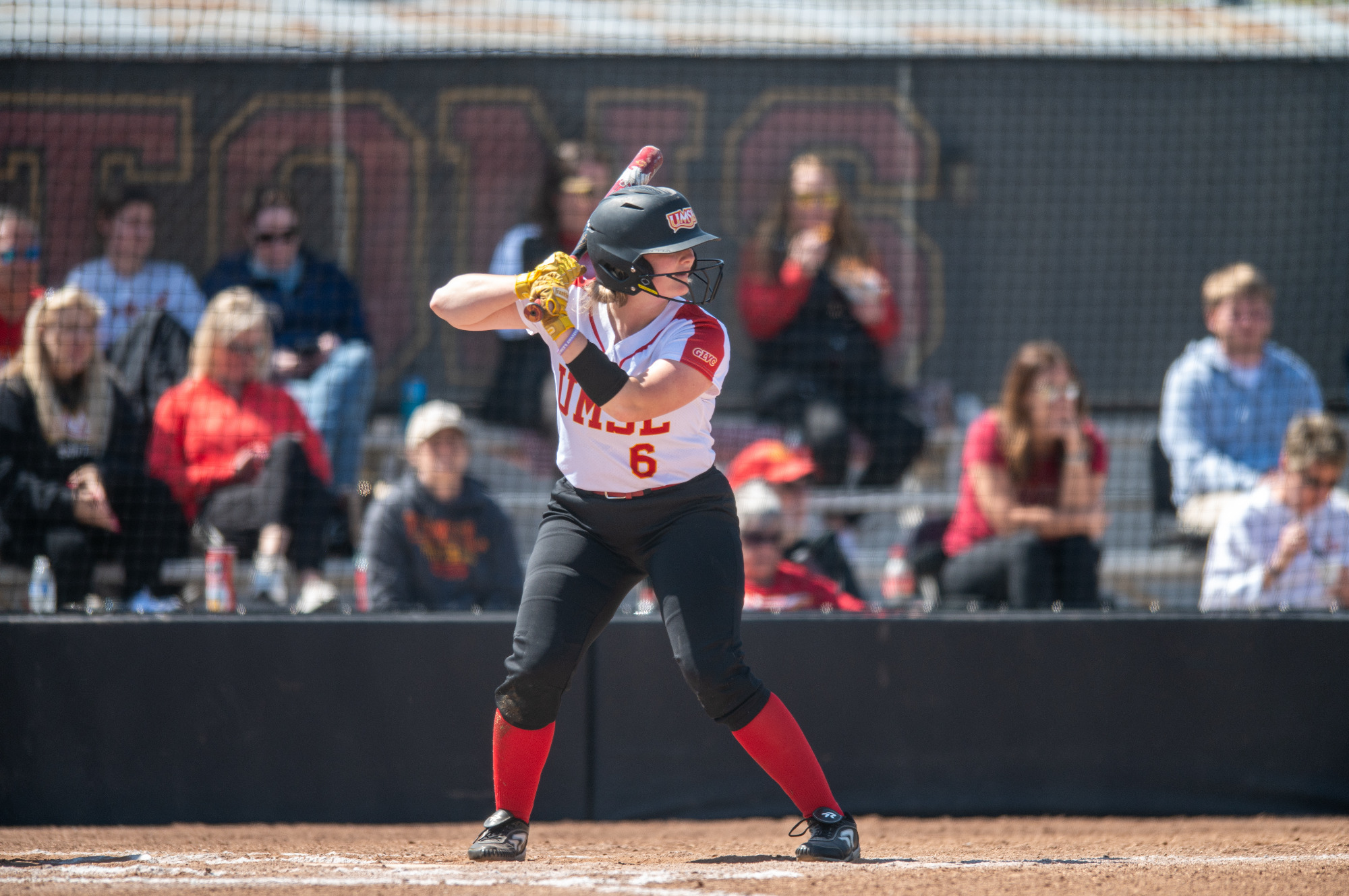 Kaytie Kossina stands at the plate waiting for a pitch to be delivered.