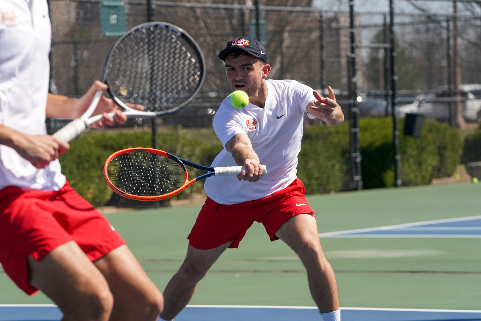 Joan Garros returns a shot in a doubles tennis match against Northwest Missouri State