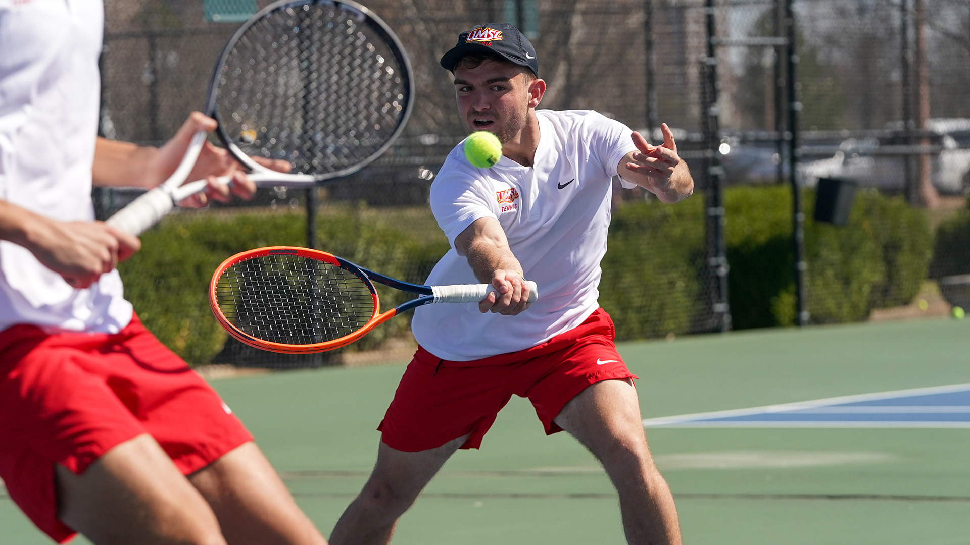 Joan Garros returns a shot in a doubles tennis match against Northwest Missouri State