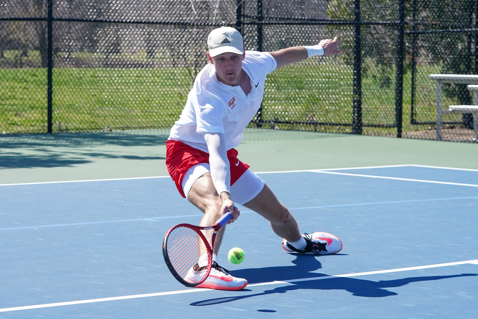 Tommy Griese charges to the net to go down and return a ball in a match against Northwest Missouri State