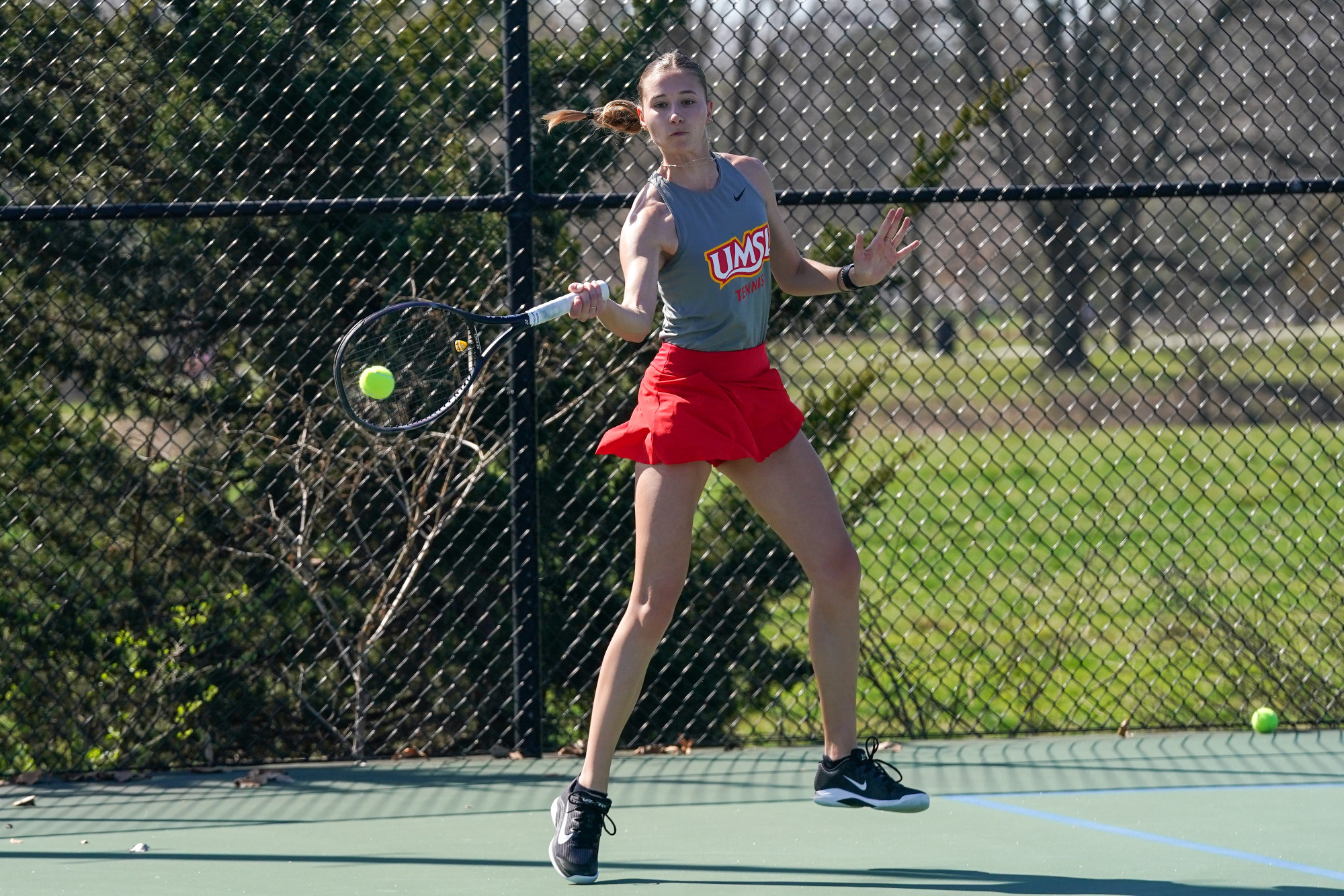Anna Favaron hits a forehand shot in a women's tennis match against Northwest Missouri State