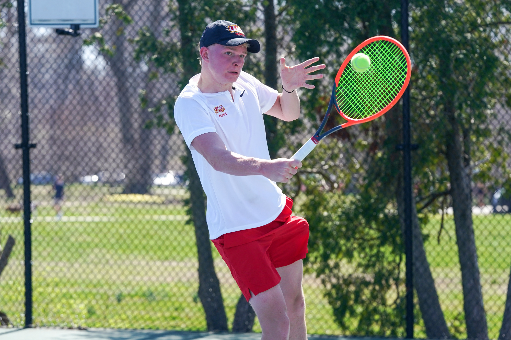 Percy Siercke hitting a backhand shot in a match against Northwest Missouri State