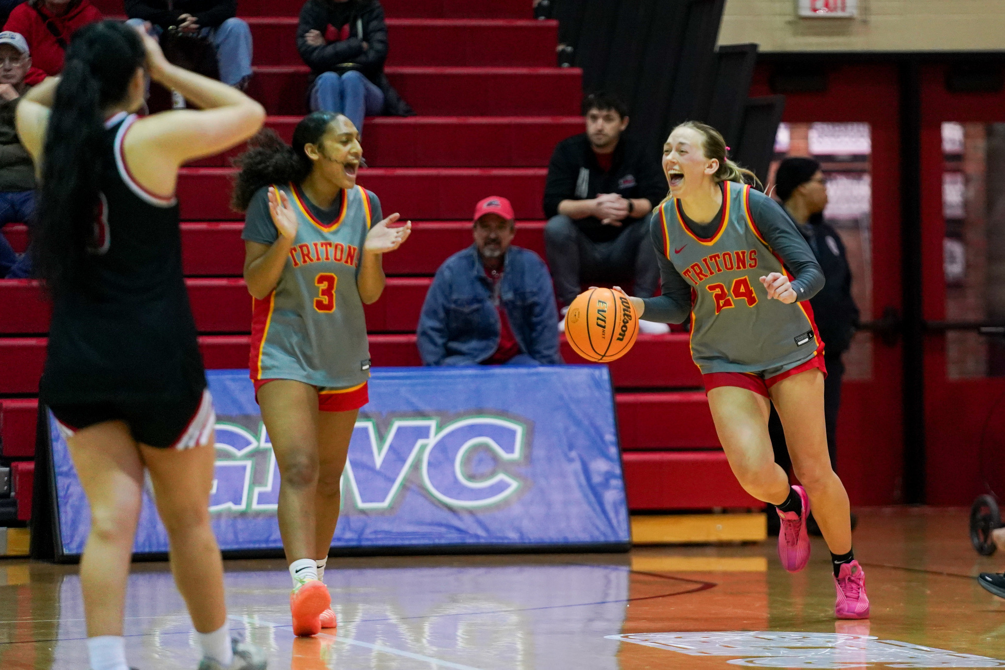 Morgan Ramthun dribbles the basketball to run out the clock as Jaeda Wilson claps in UMSL's 66-59 win over Lewis on March 7