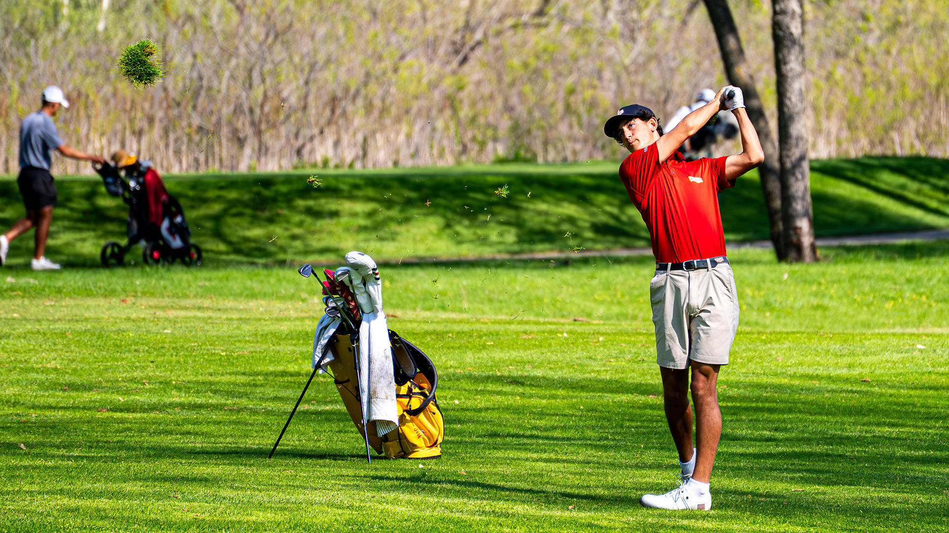 Trigg Lindahl hits a shot from the fairway towards the green on the first day of the Great Lakes Valley Conference men's golf championships
