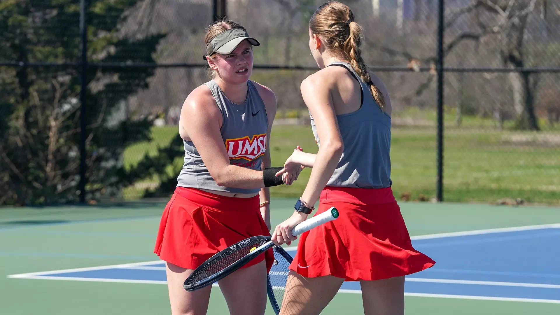 Lauren Sweeney (L) and Anna Favaron (R) celebrate after winning a point in a doubles match against Northwest Missouri State