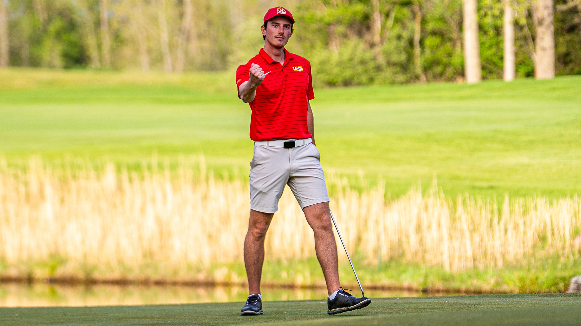 Leo Baudry gives a fist pump after winning his match in the Great Lakes Valley Conference medal/match play final against Missouri S&T
