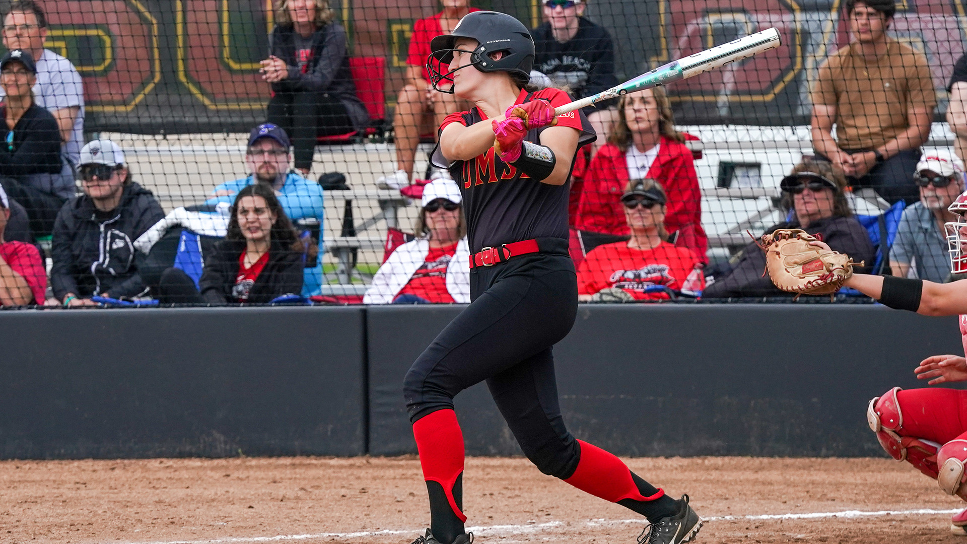 Maddie Illingworth follows through on a swing after hitting a softball
