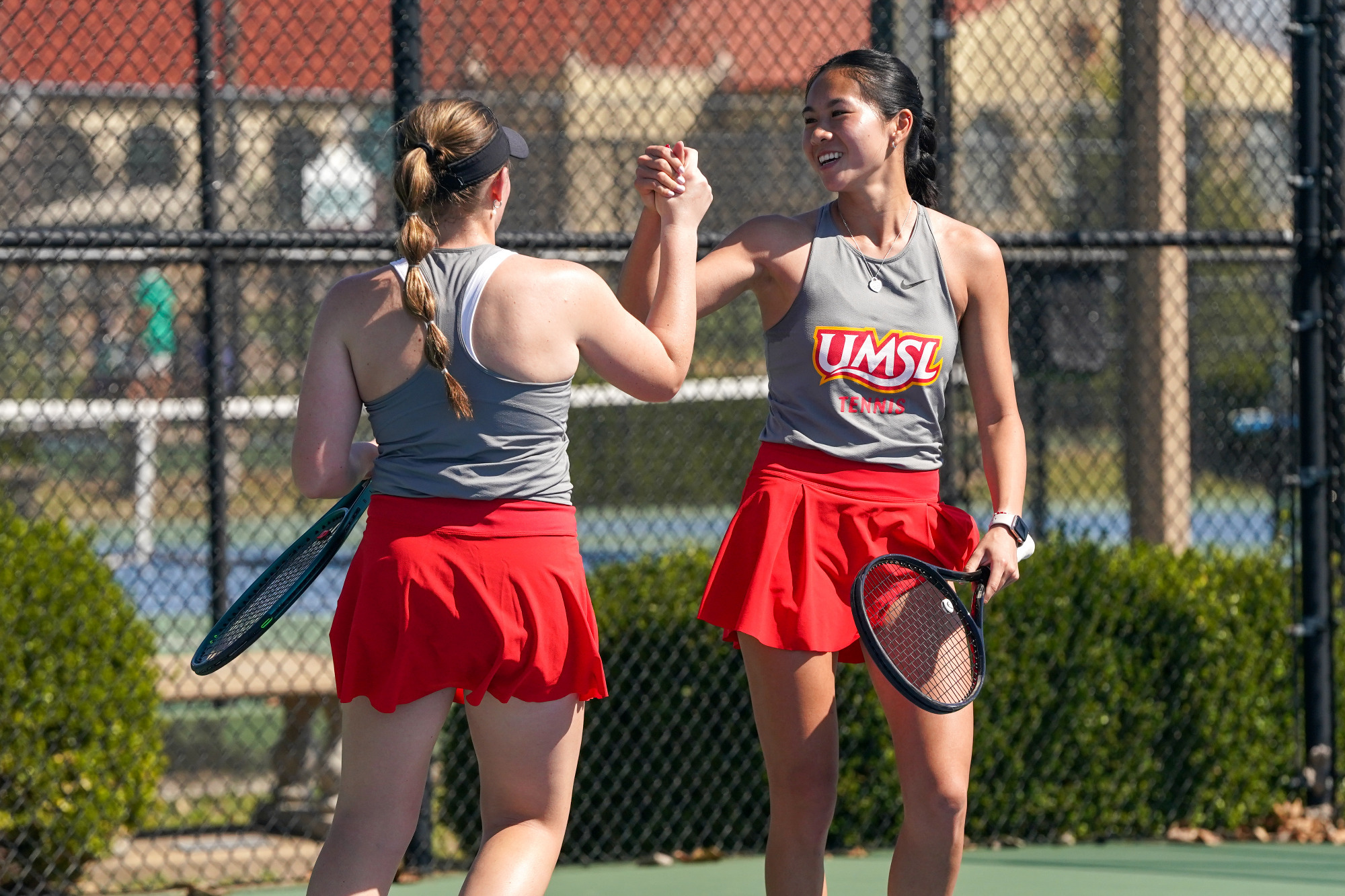 Hannah Tse and Morgan Lint congratulate either after winning a doubles match