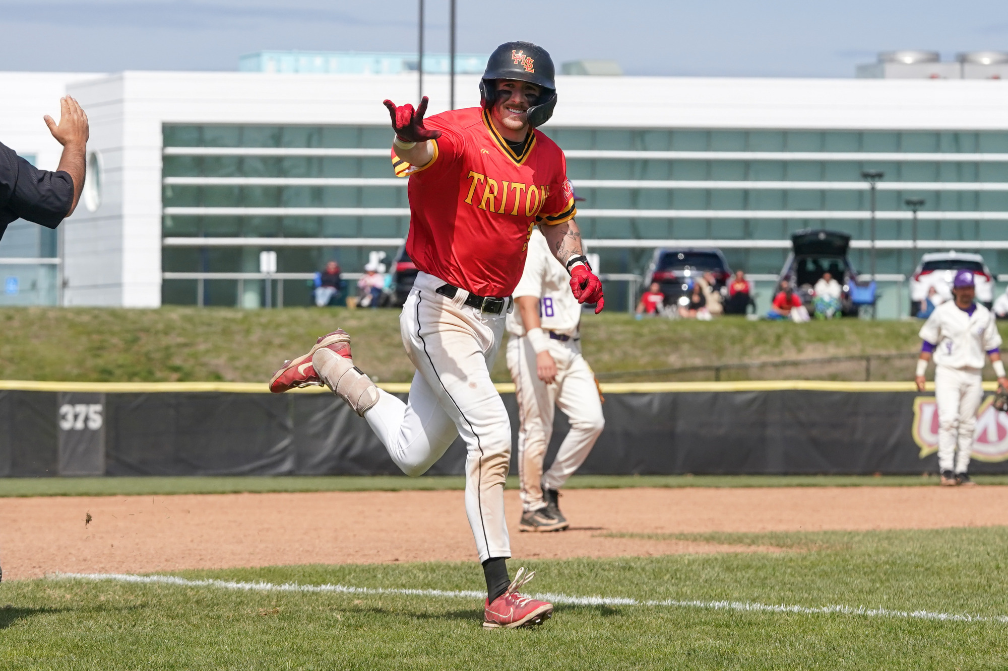 Mitch Bonczkowski flashes a sign to the dugout after rounding third during his home run trot