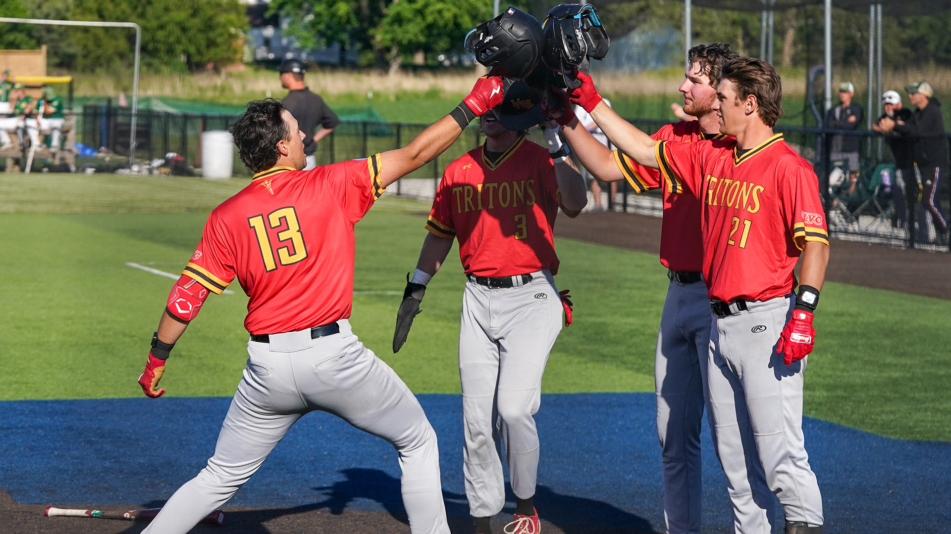 Bennett Cagle (L) is congratulated by Mitch Bonczkowski (far right), Justin Terhaar (middle) and Cade Grevengoed (near right) after hitting a three-run home run in the ninth inning