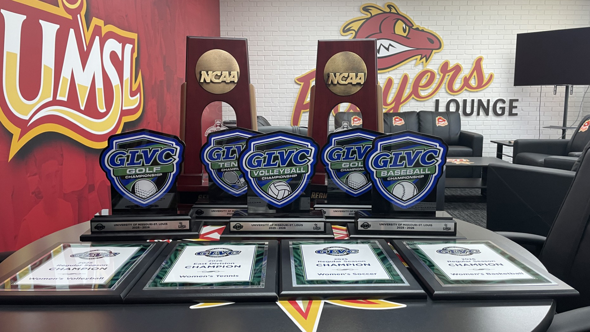 2025-26 GLVC and NCAA Trophies won by UMSL Athletics. Bottom Row (L-R): Volleyball (regular season), women's tennis (division champs), women's soccer (regular season), women's basketball (regular season). Middle Row: women's golf (conference), women's tennis (conference), volleyball (conference), men's golf (conference) and baseball (conference). Back Row (L-R): men's golf (semifinal trophy) and women's soccer (regional champion trophy).