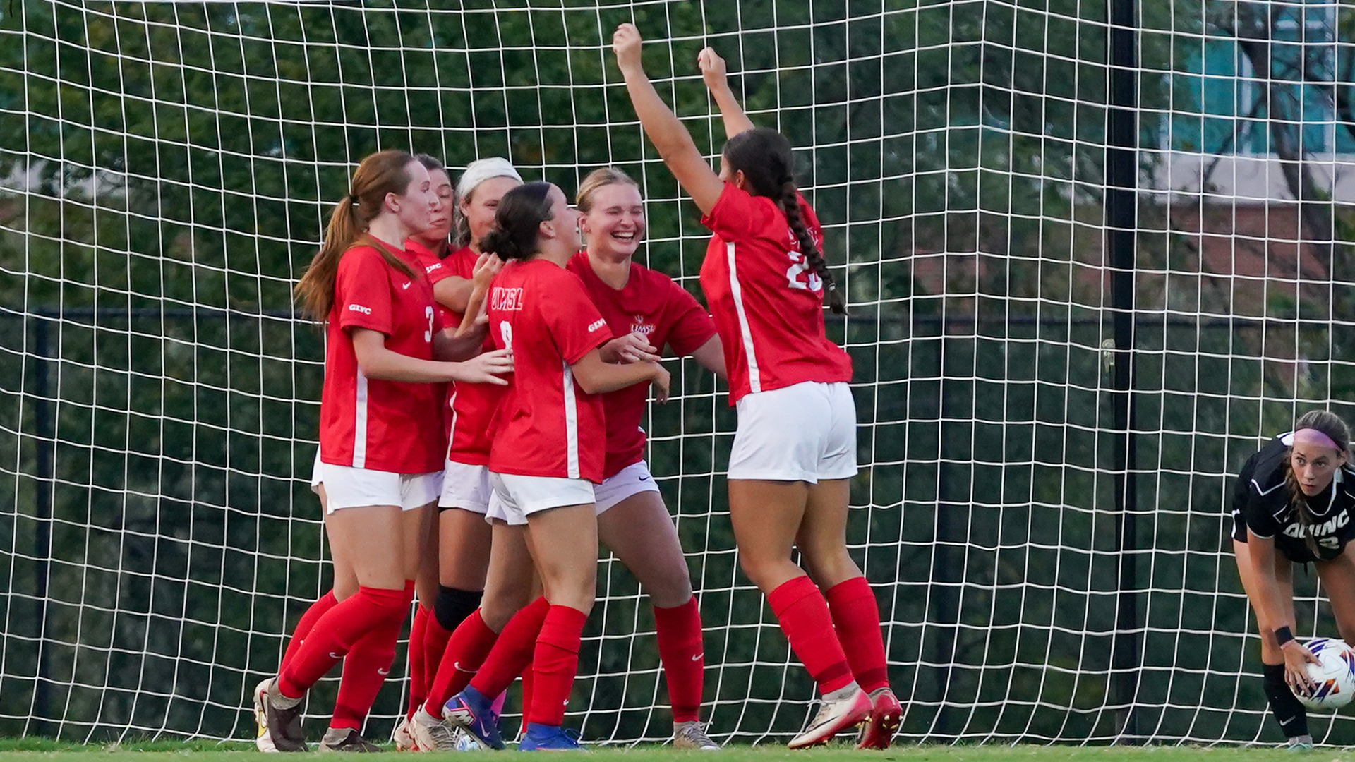 UMSL women's soccer players celebrate after scoring a goal in a game against Quincy.