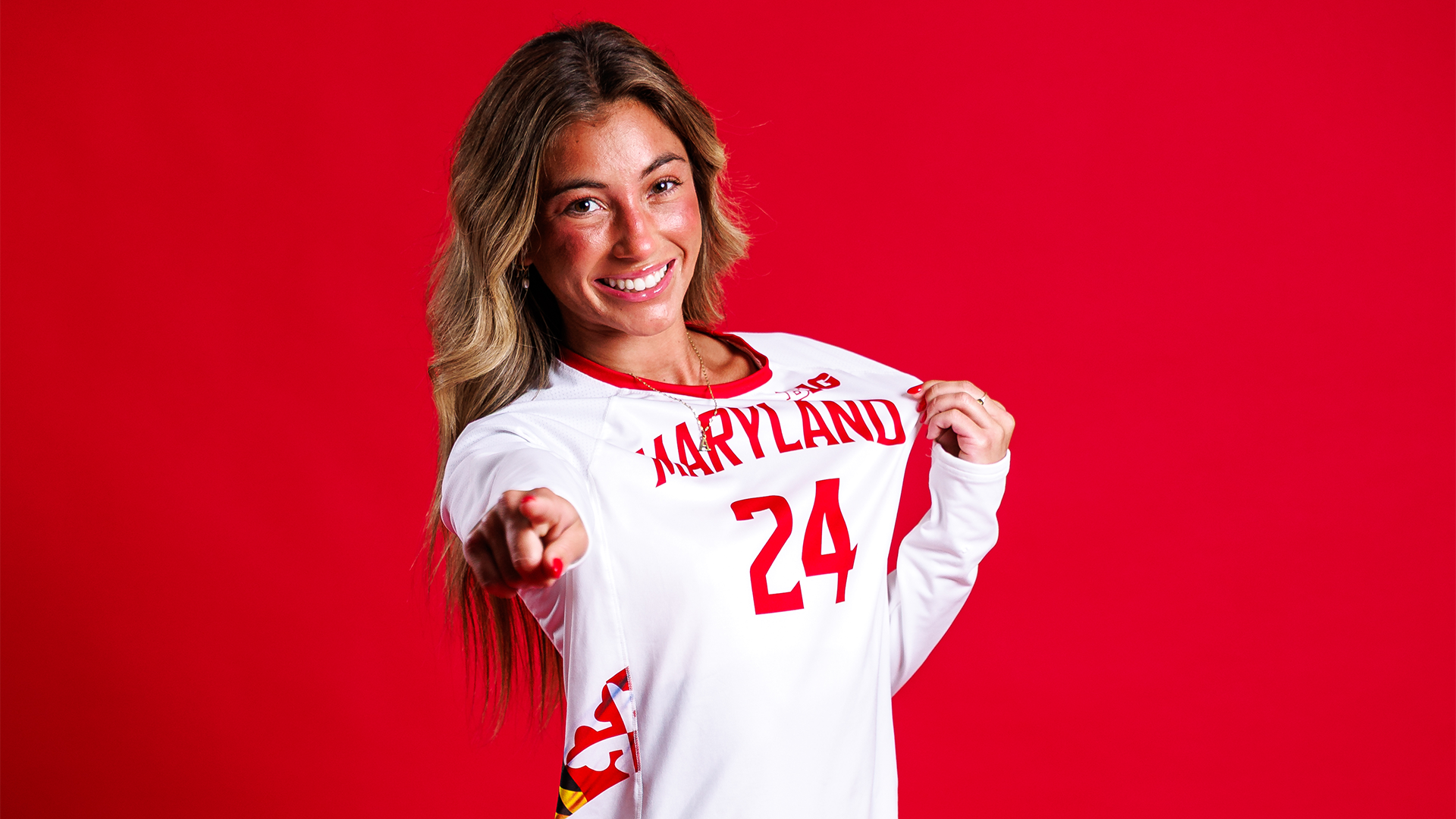 Ally Williams posed red backdrop 