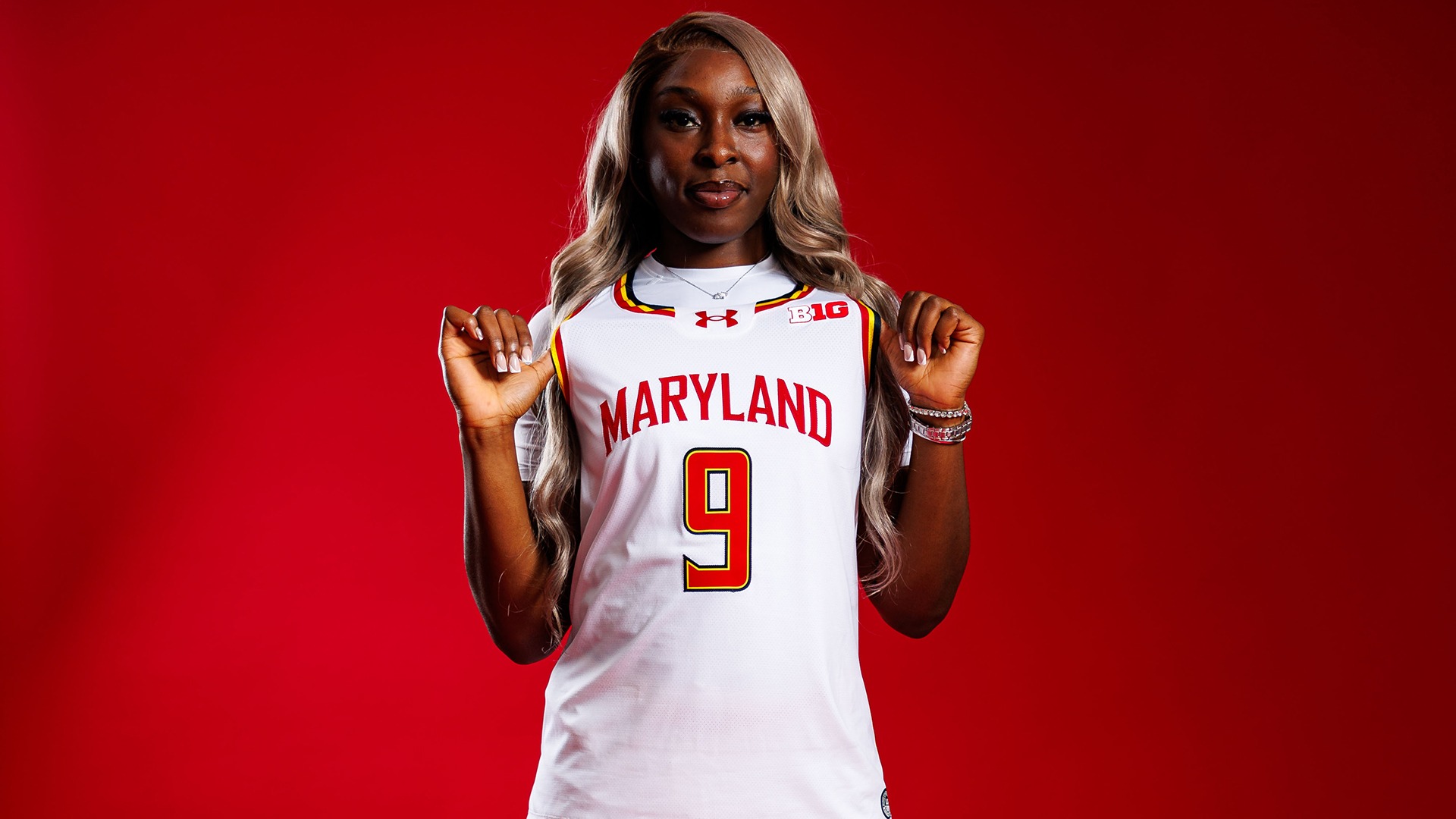 Isi Ozzy-Momodu posed red background 