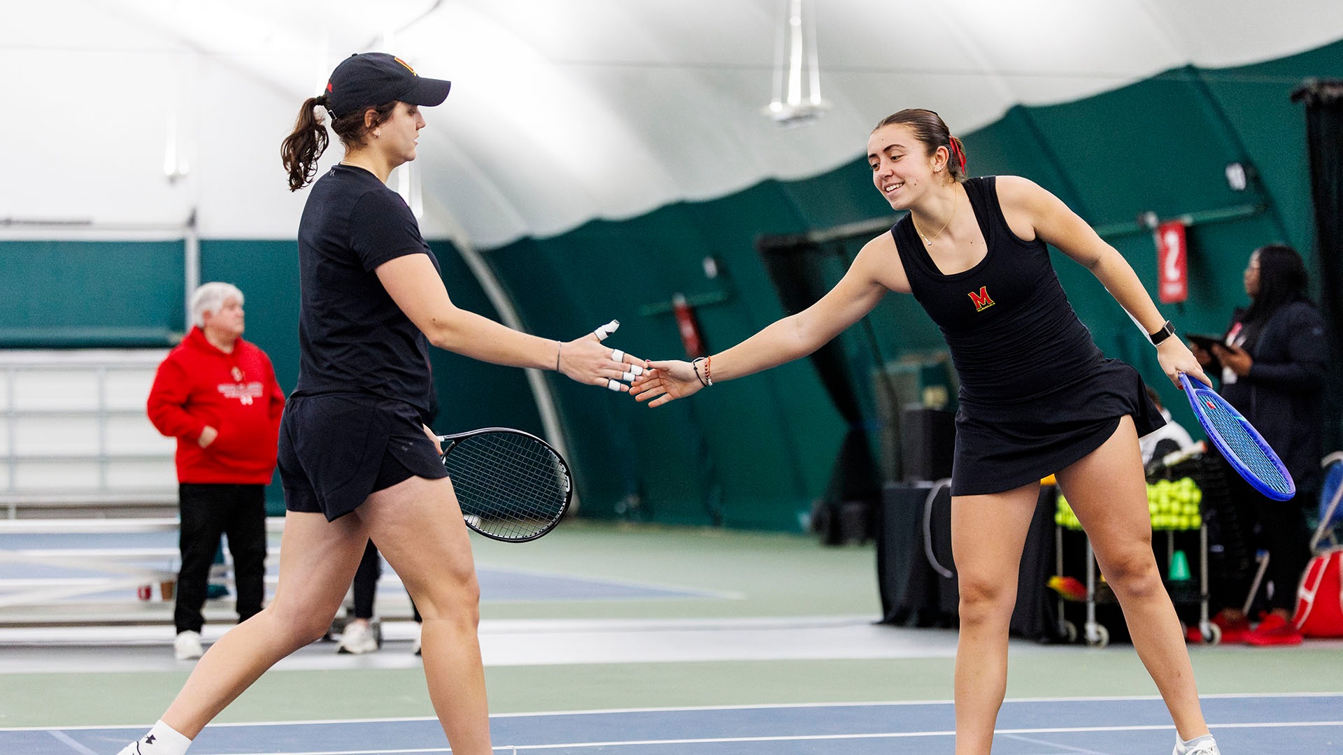 Ema Kovacevic high fiving Emma Ghirardato after a doubles point