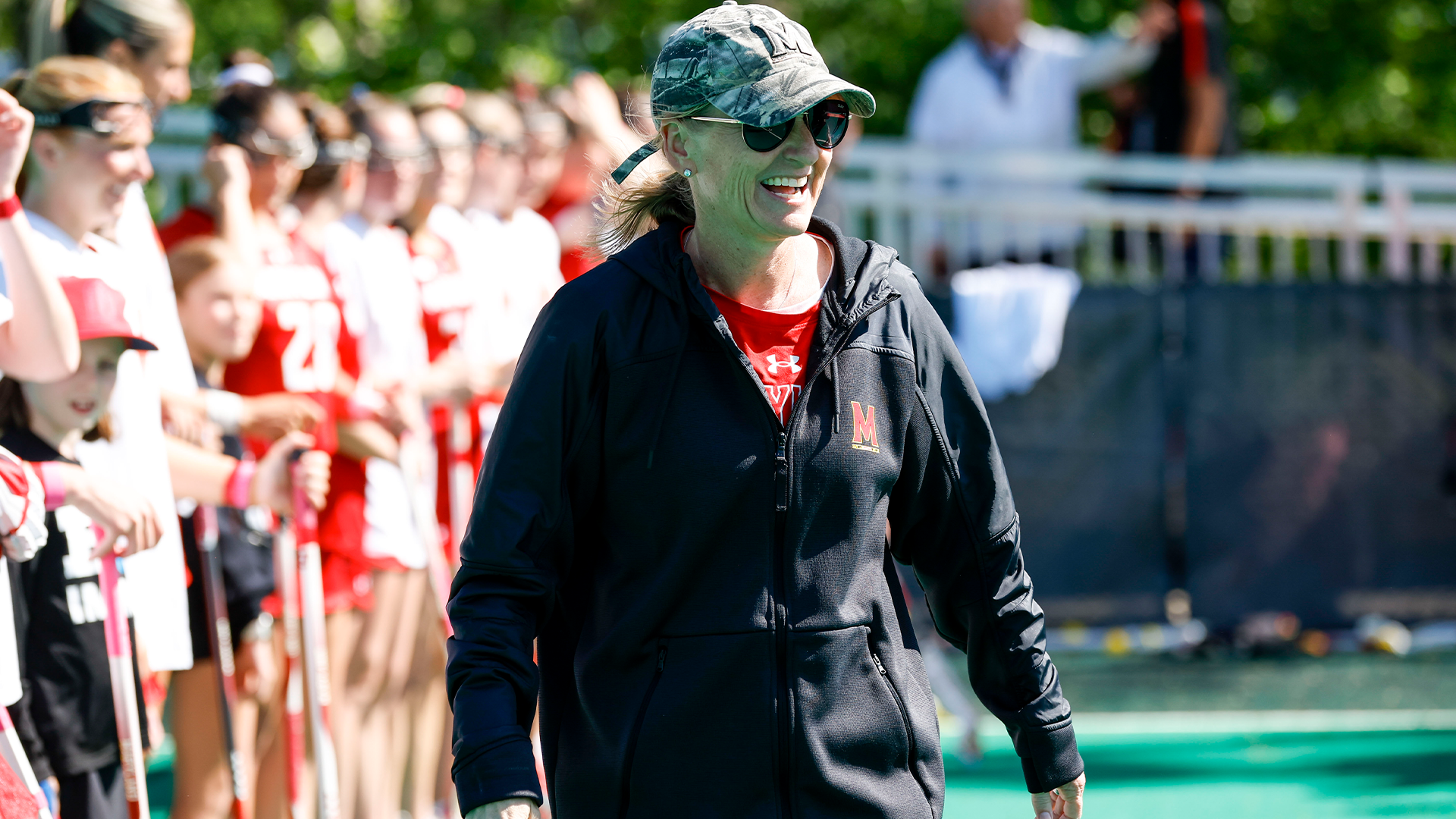 Head Coach Cathy Reese smiling in pregame warmups 