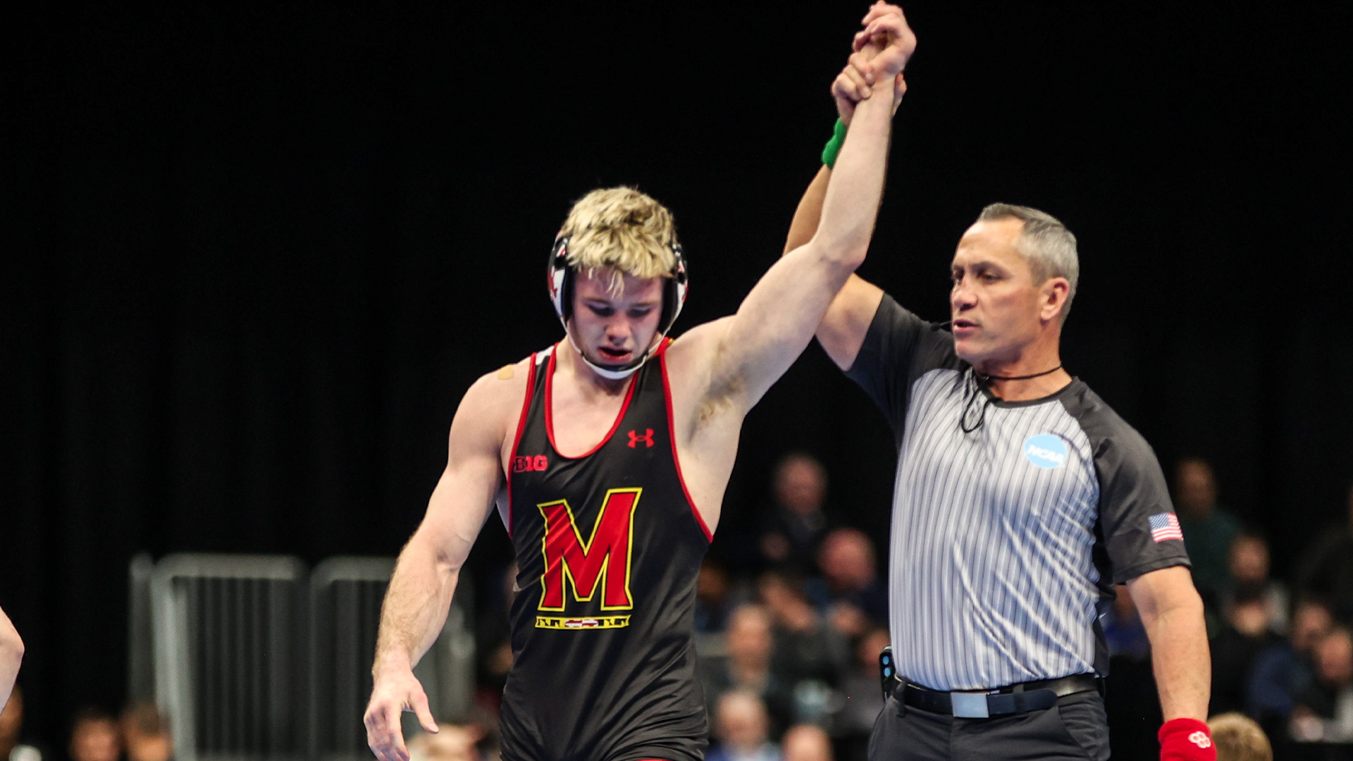 Carter Young gets his hand raised after advancing to the NCAA QF
