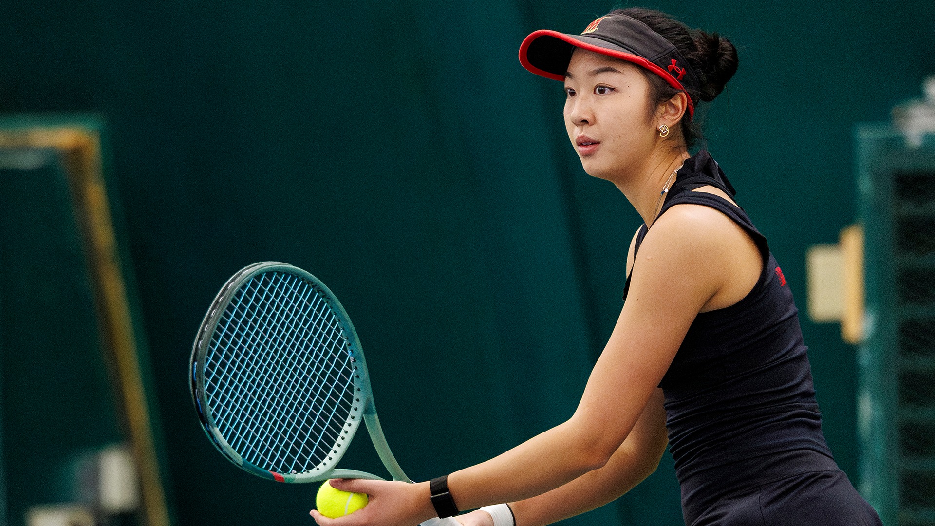 Katherine Hung setting up her serve versus Loyola Maryland