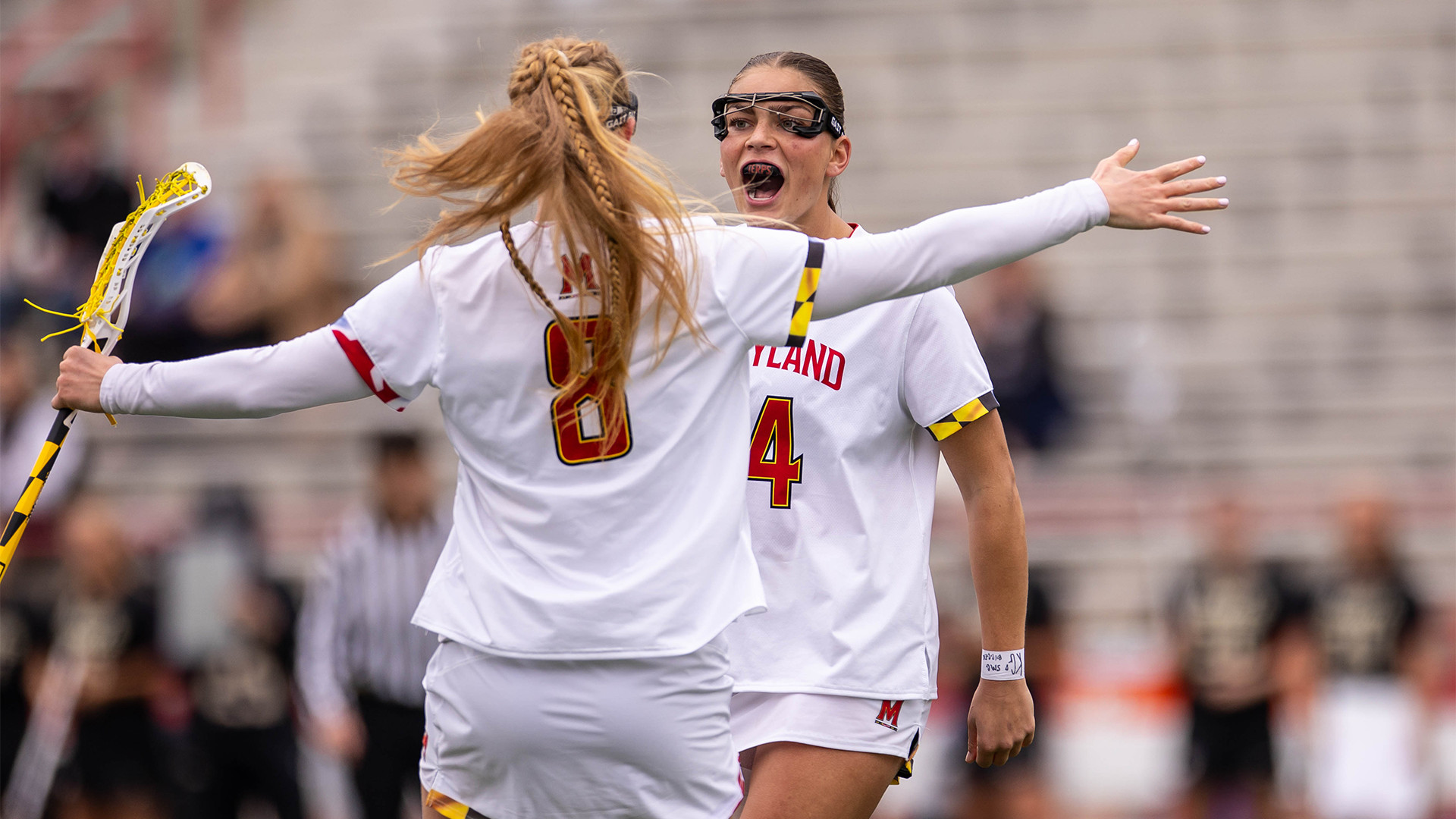 Lauren LaPointe and Kori Edmondson celebrate a goal against James Madison at SECU Stadium