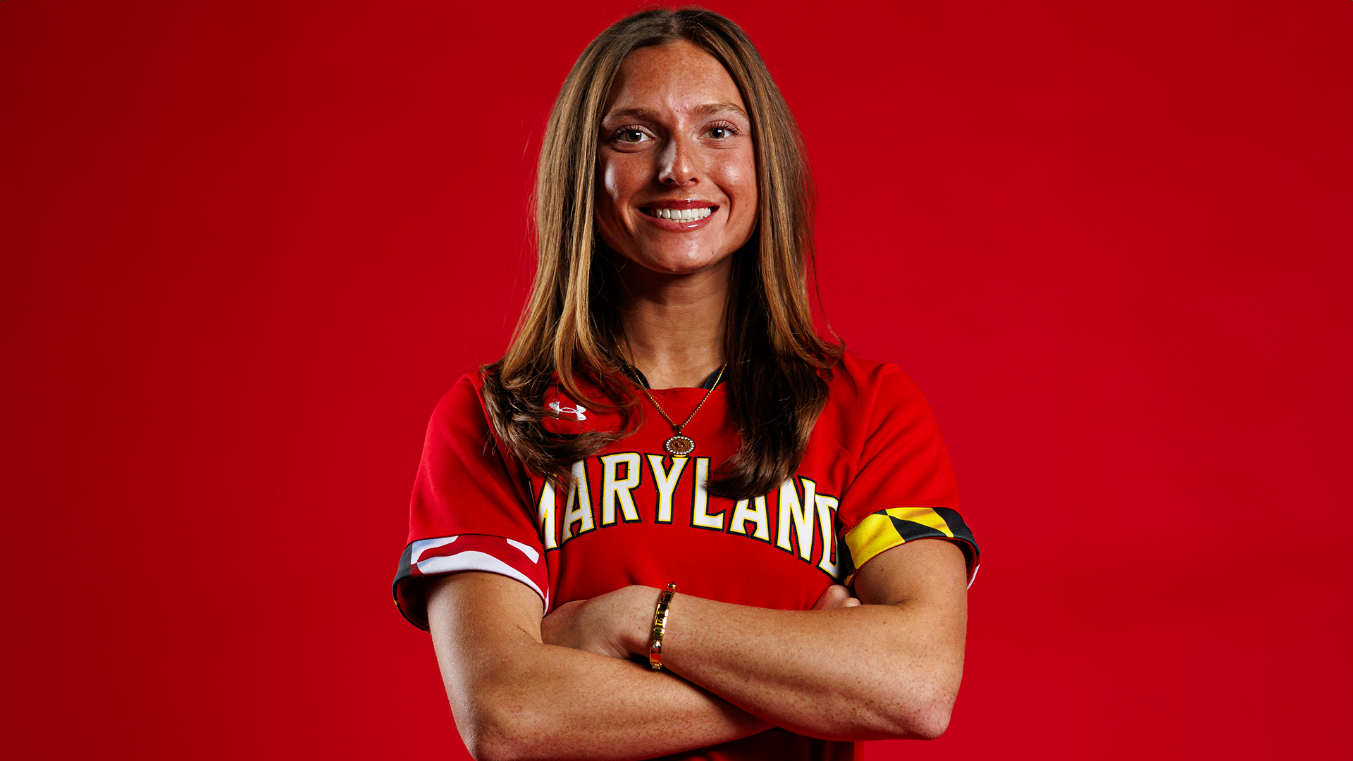 Caitlyn Cornwell red background posed action photo