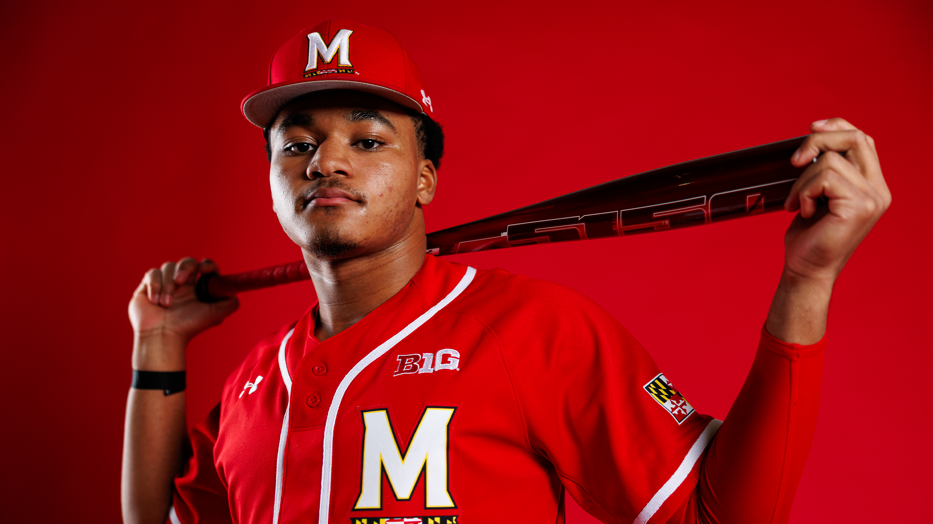 Paul Jones Story Cover Photo - posing in front of red background
