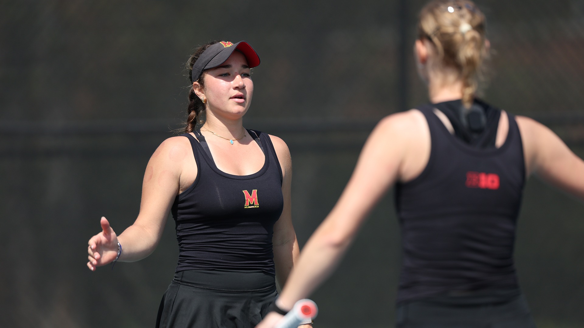 Aida Eissa and Oliwia Orlinska high fiving after winning their doubles match