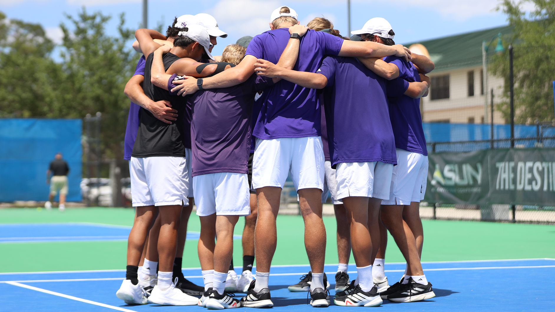 2026 Men's Tennis team huddle at ASUN Tournament