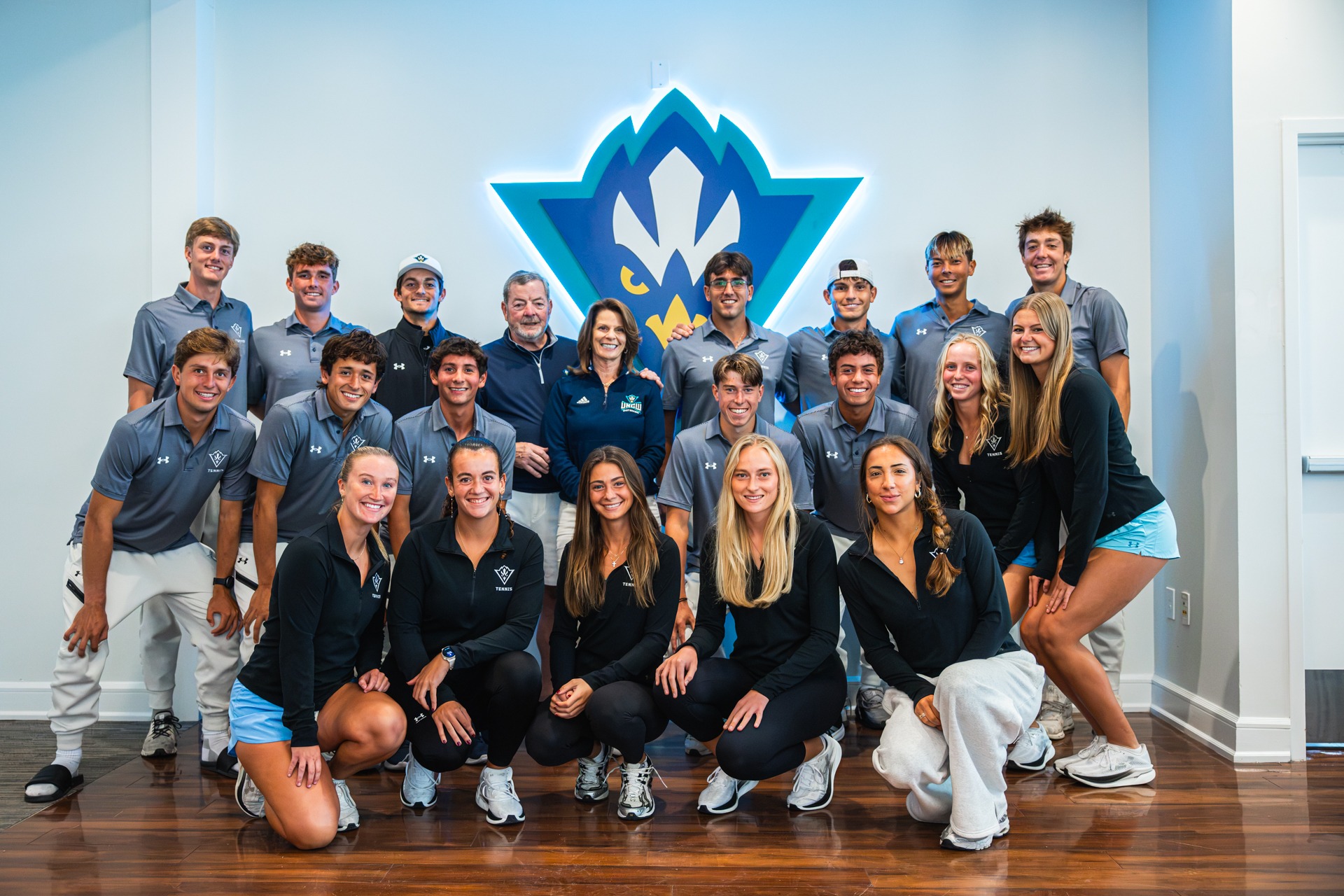 Photo of Michael McCarley and Nancy Langevin with Men's and Women's Tennis announcing the largest philanthropic gift in UNCW Athletics history