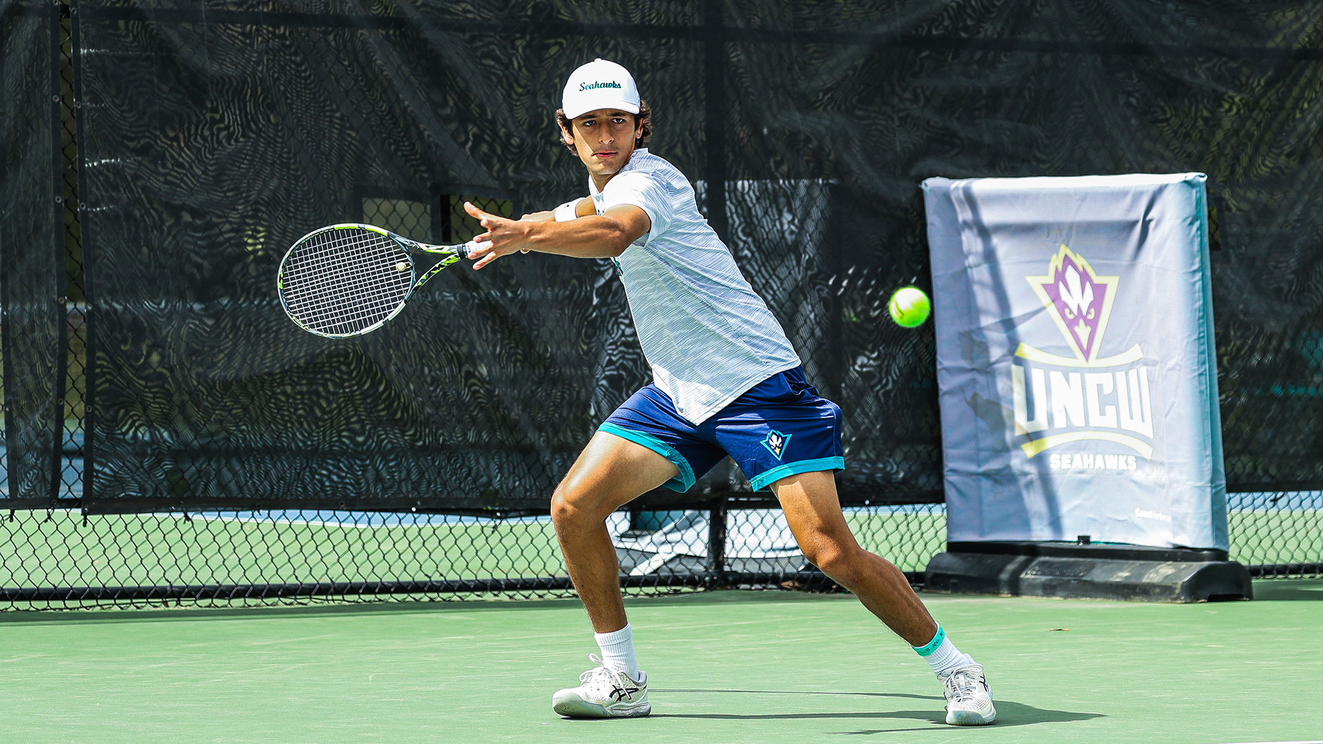 tennis player returns a shot