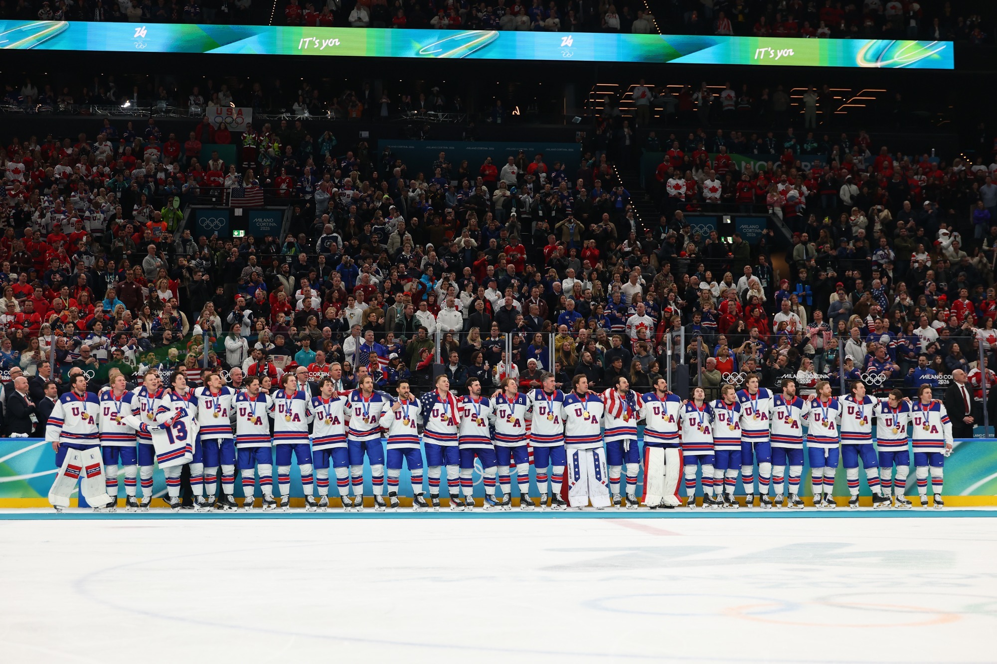 MILAN, ITALY - FEBRUARY 22: Gold medalists Team United States participates in the national anthem during the medal ceremony following the Men's Gold Medal match between Canada and the United States on day 16 of the Milano Cortina 2026 Winter Olympic games at Milano Santagiulia Ice Hockey Arena on February 22, 2026 in Milan, Italy. (Photo by Gregory Shamus/Getty Images)